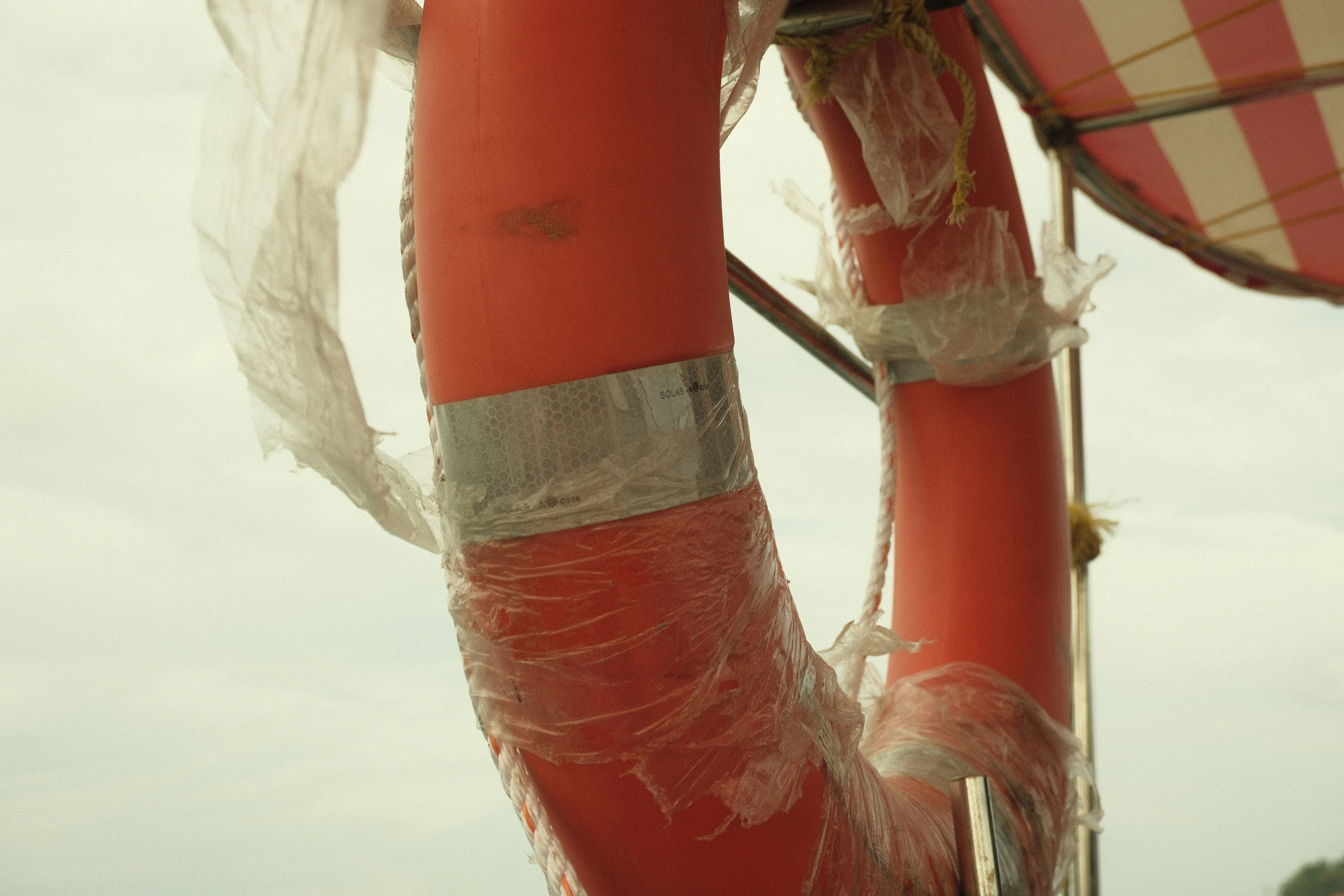 Orange life preserver wrapped in plastic
