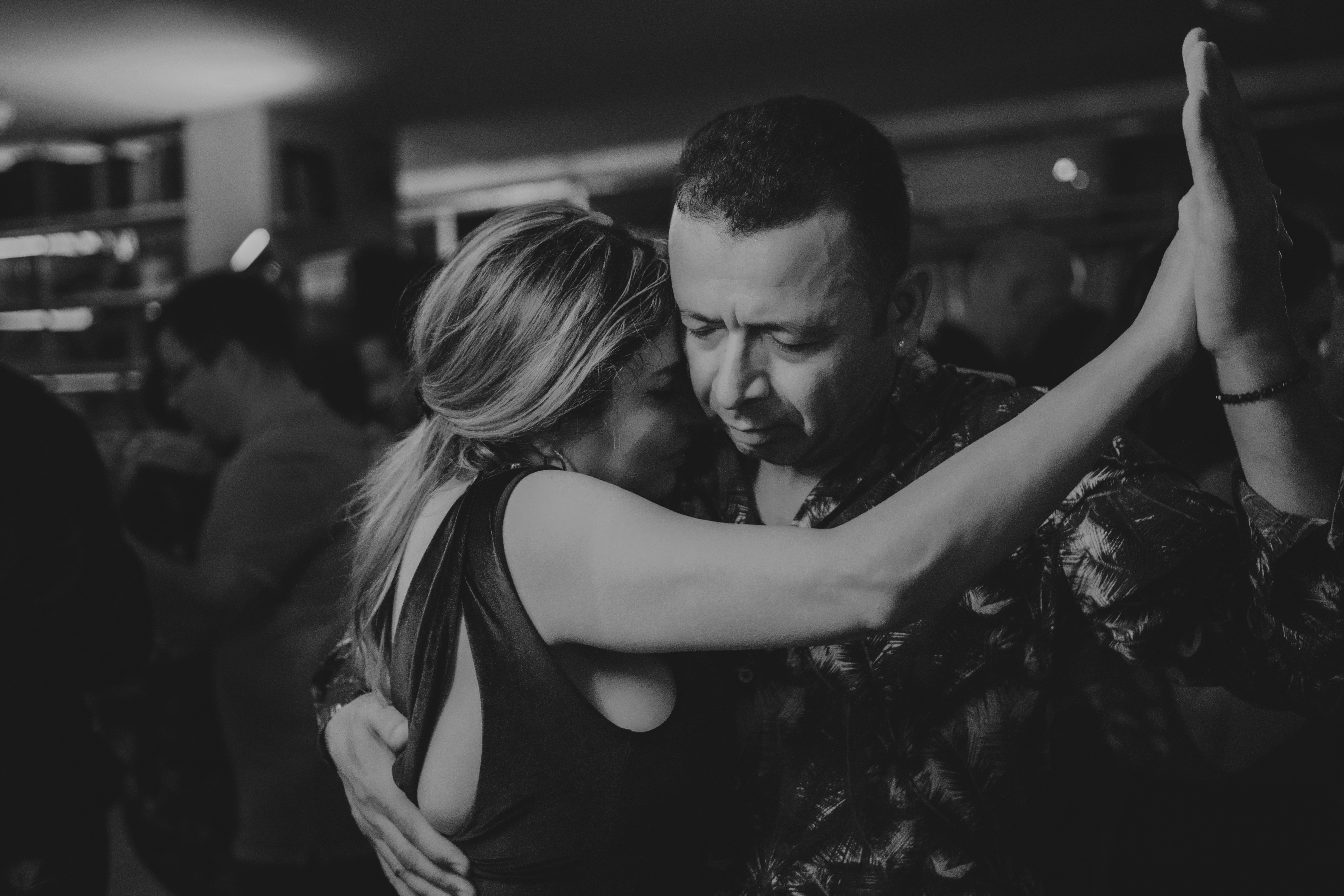 Couple dancing closely in a dimly lit room