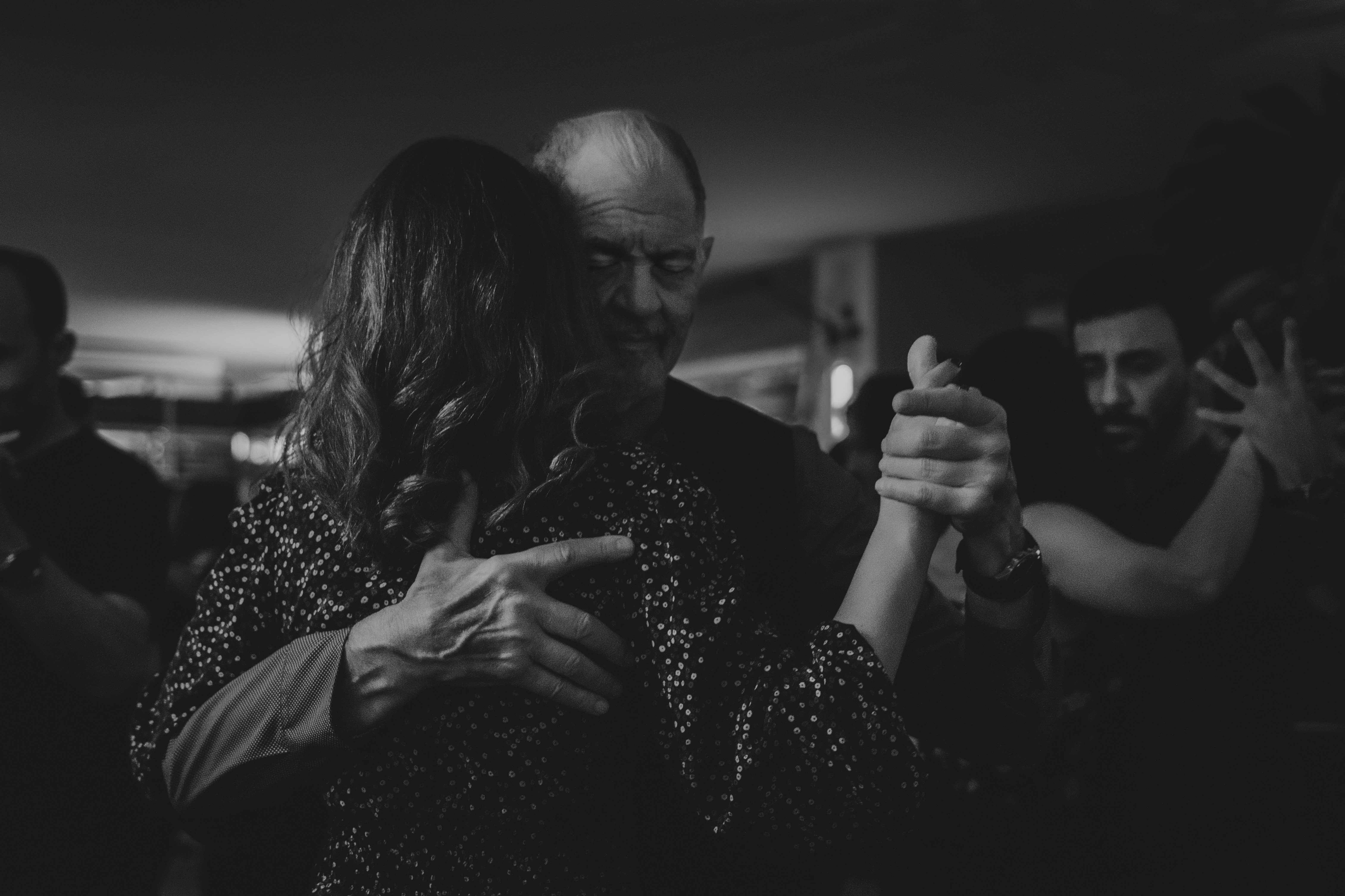 Couple dancing tango in a dimly lit room