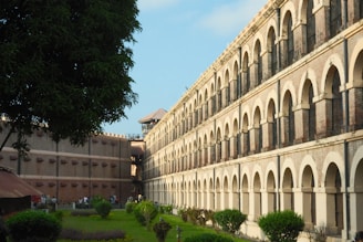 Historic colonial building with arched walkways and courtyard