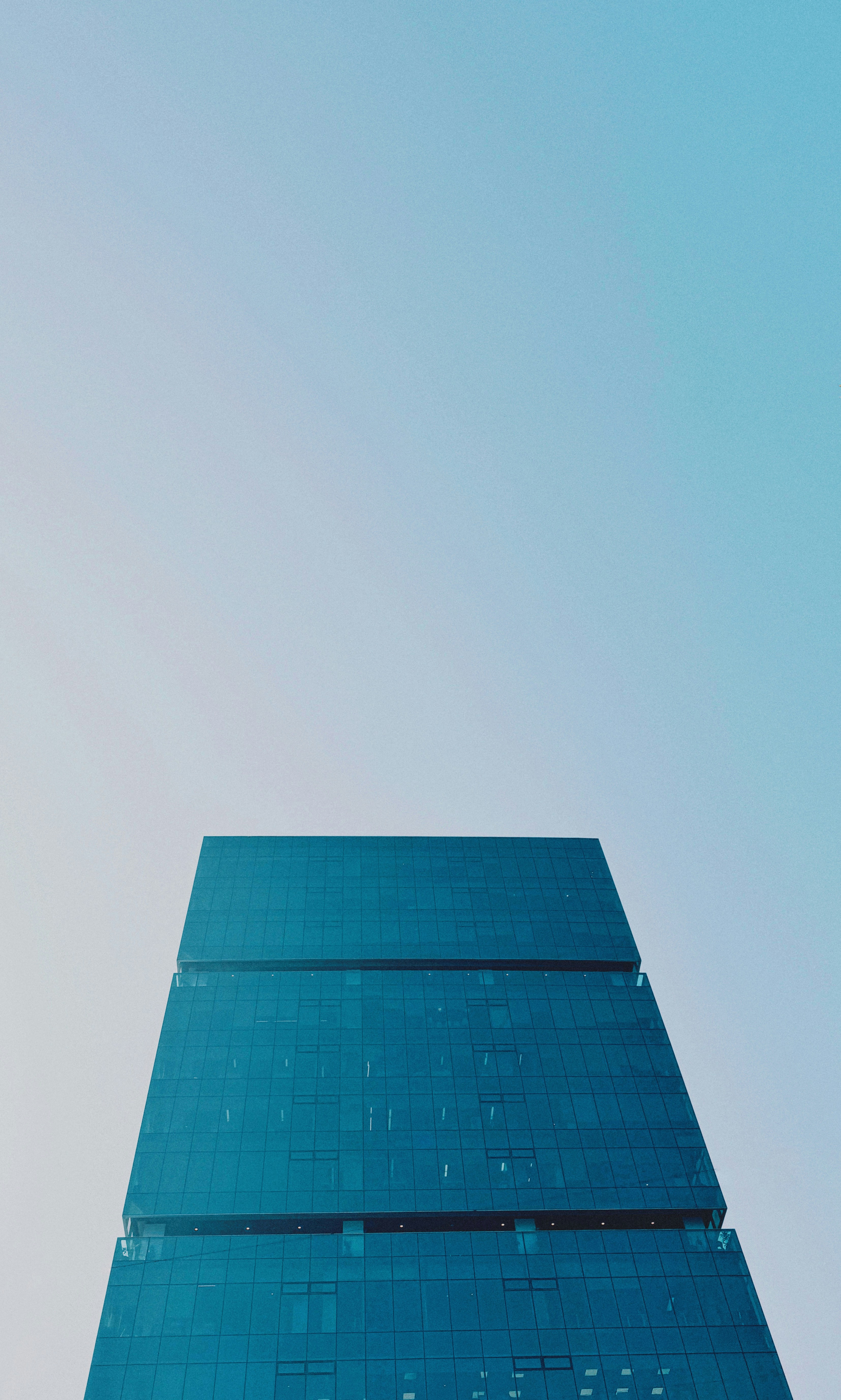 Modern blue skyscraper against a clear sky