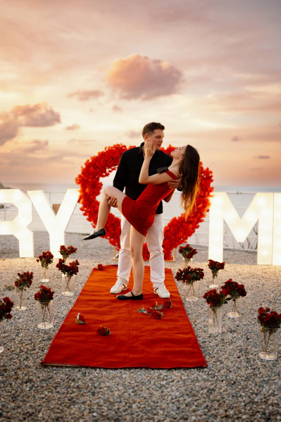 Couple's romantic proposal with roses and lights