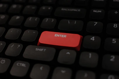 Close-up of a red enter key on a keyboard