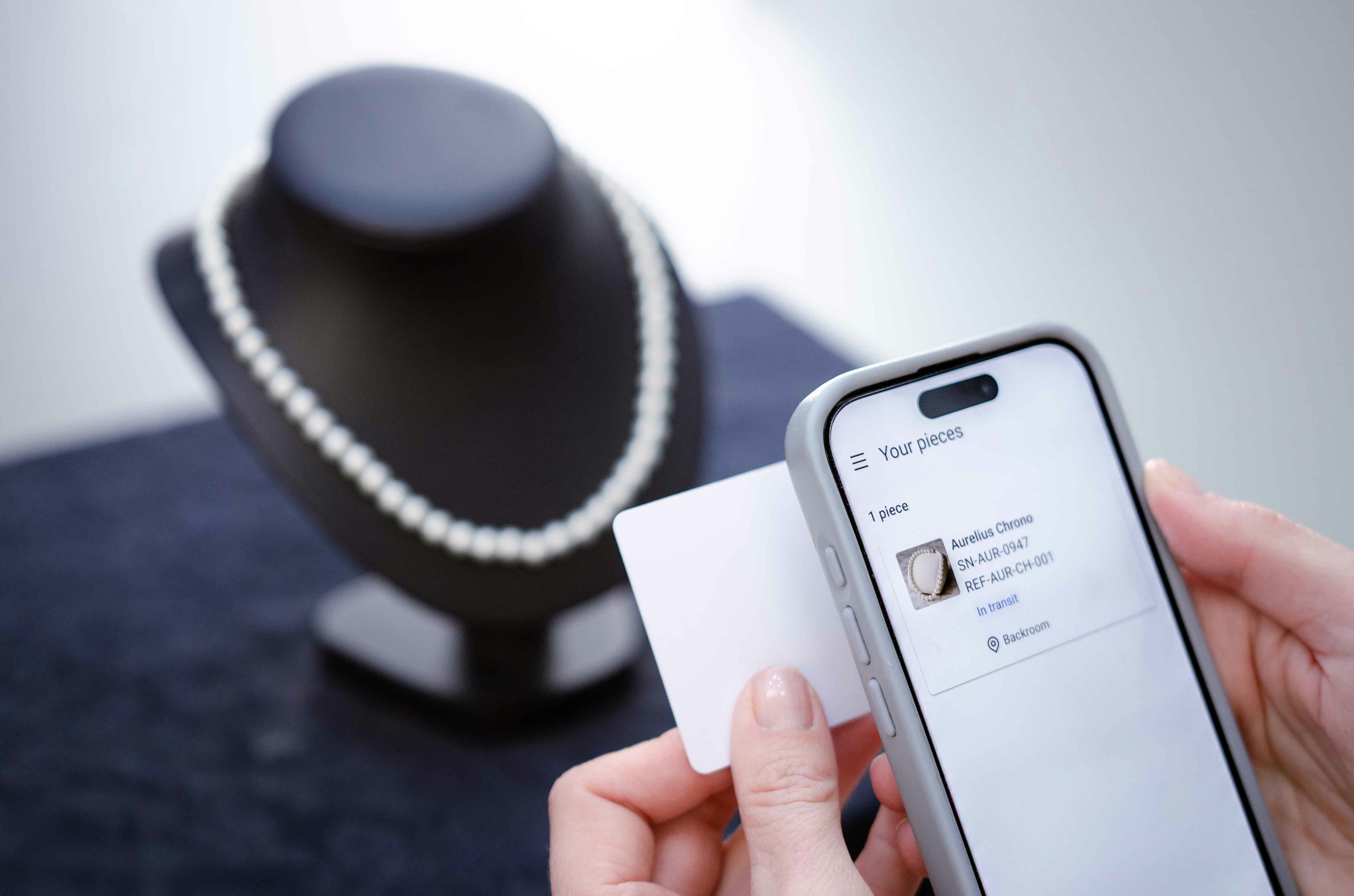 Woman scanning pearl necklace information with smartphone