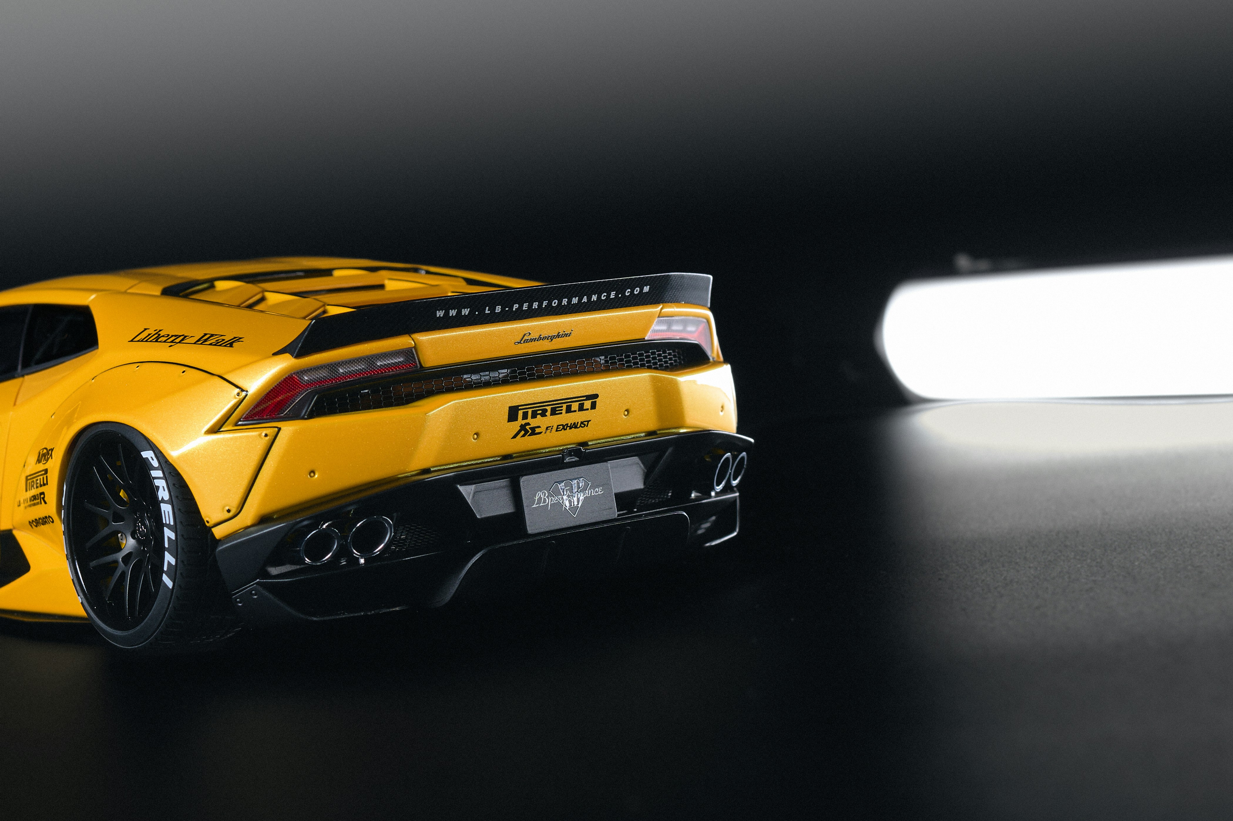 Yellow sports car with black accents on black background