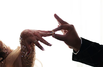 Man places ring on woman's finger