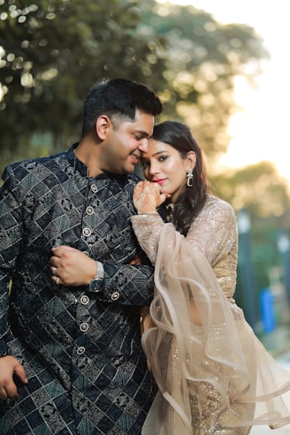 A couple embracing outdoors during golden hour.