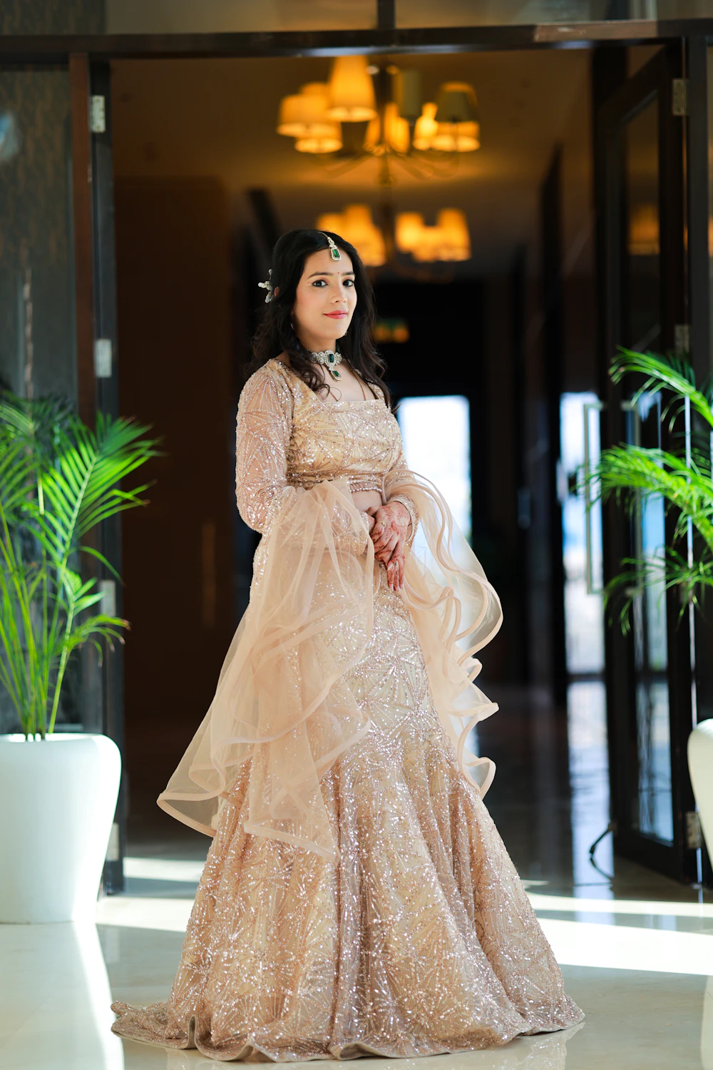 Woman in a shimmering gold lehenga
