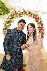 A smiling couple in traditional indian attire