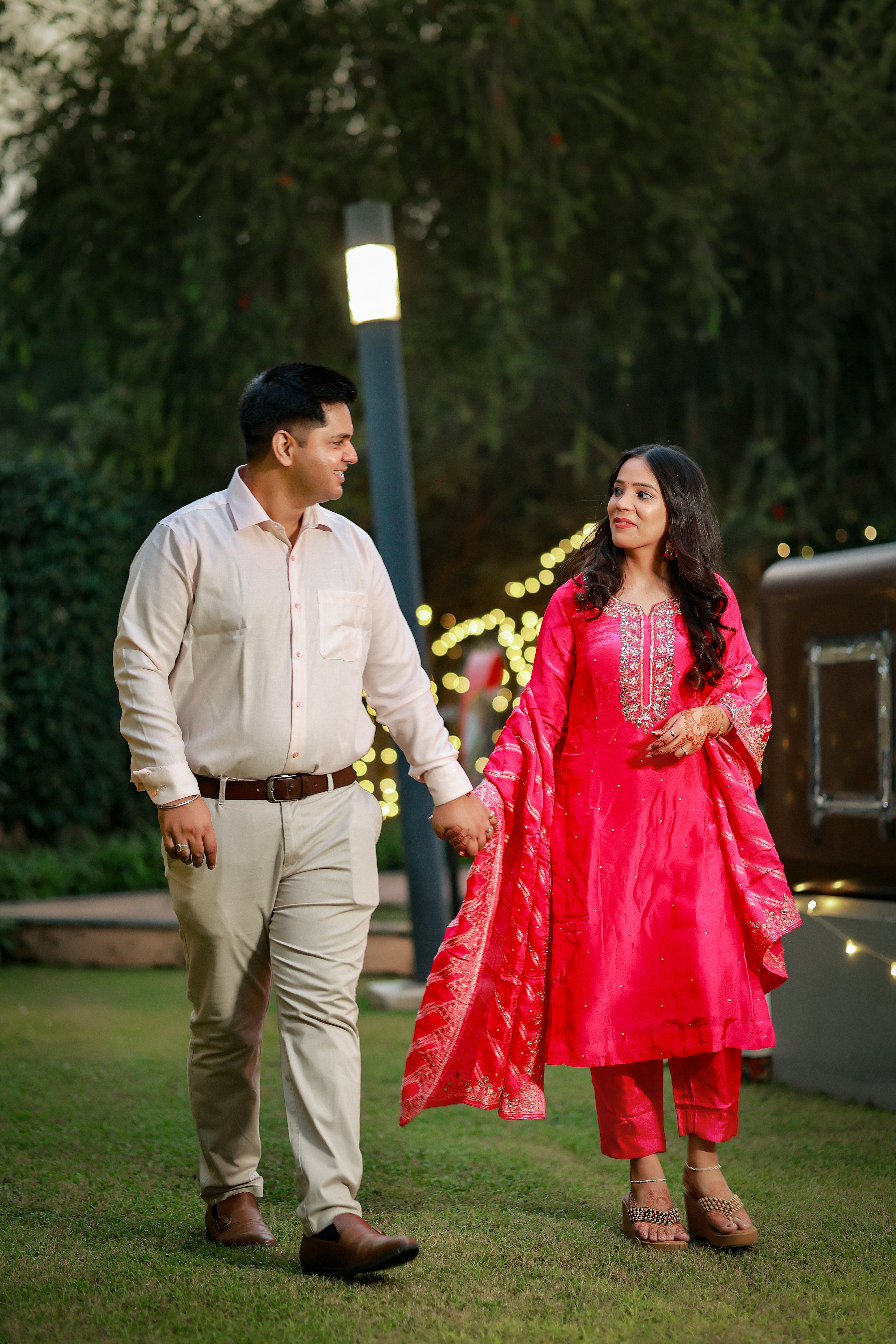 Couple holding hands walking in a garden