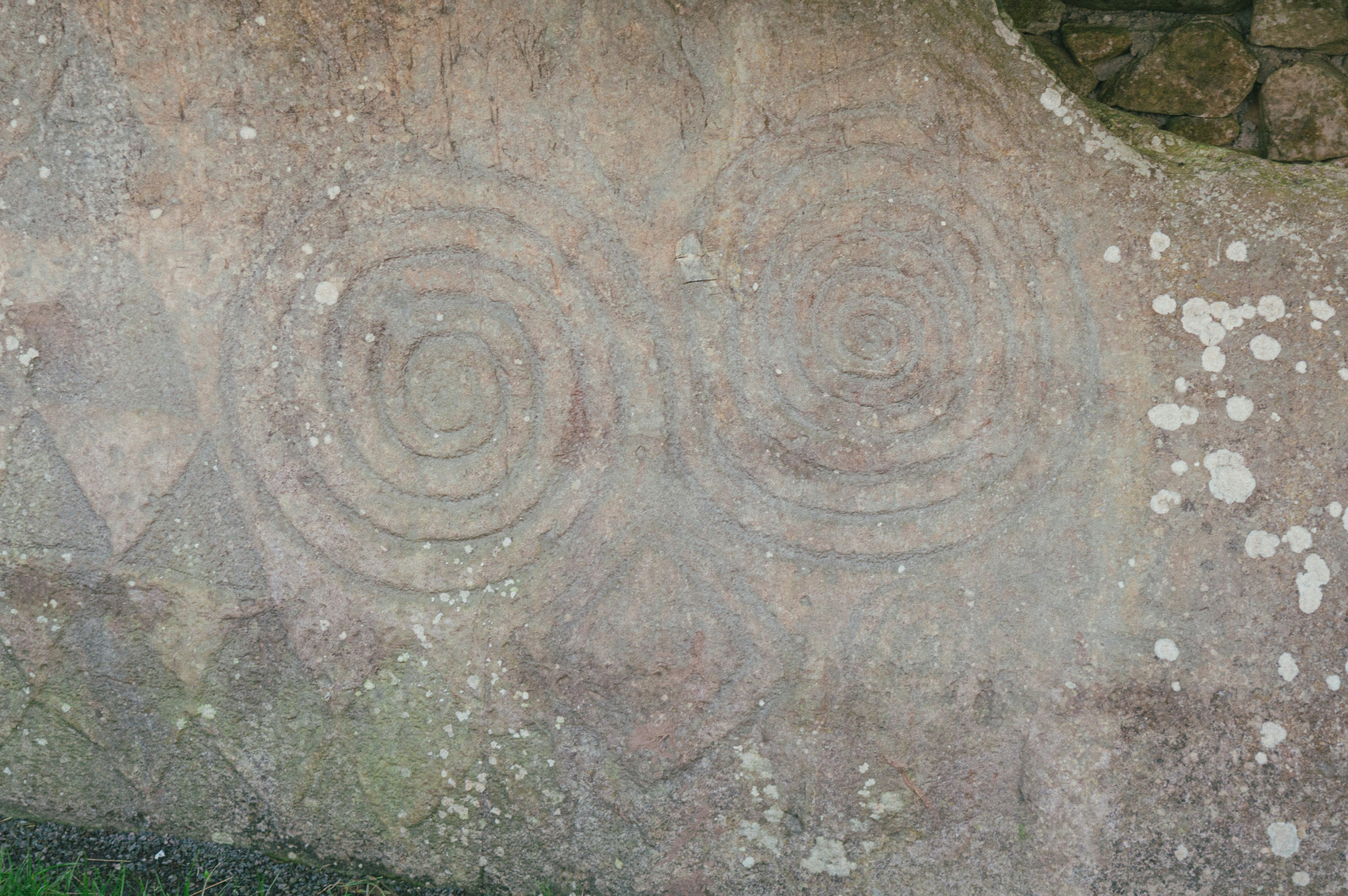 Ancient spiral carvings on a stone surface