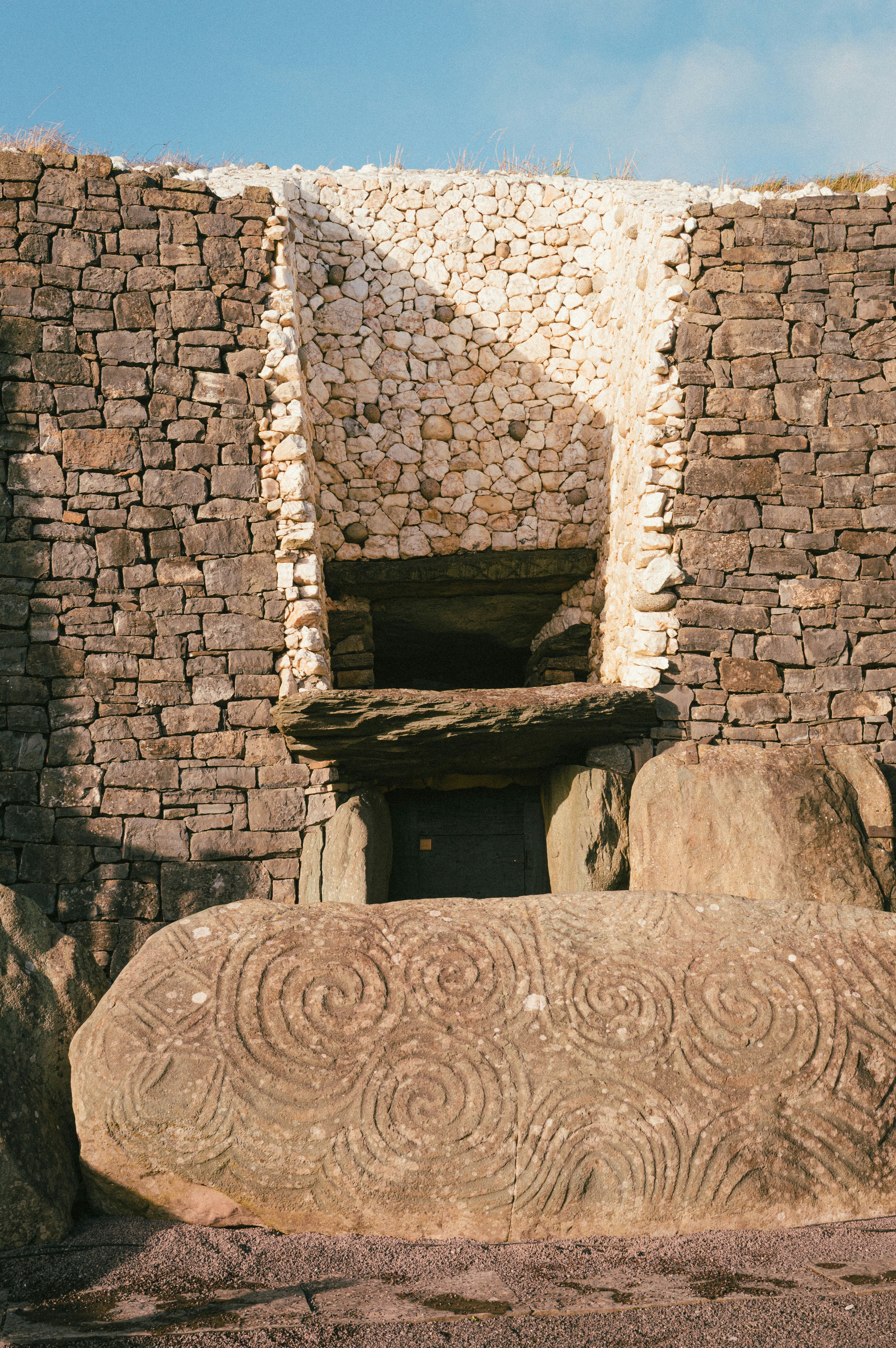 Ancient stone passage tomb entrance with spiral carvings