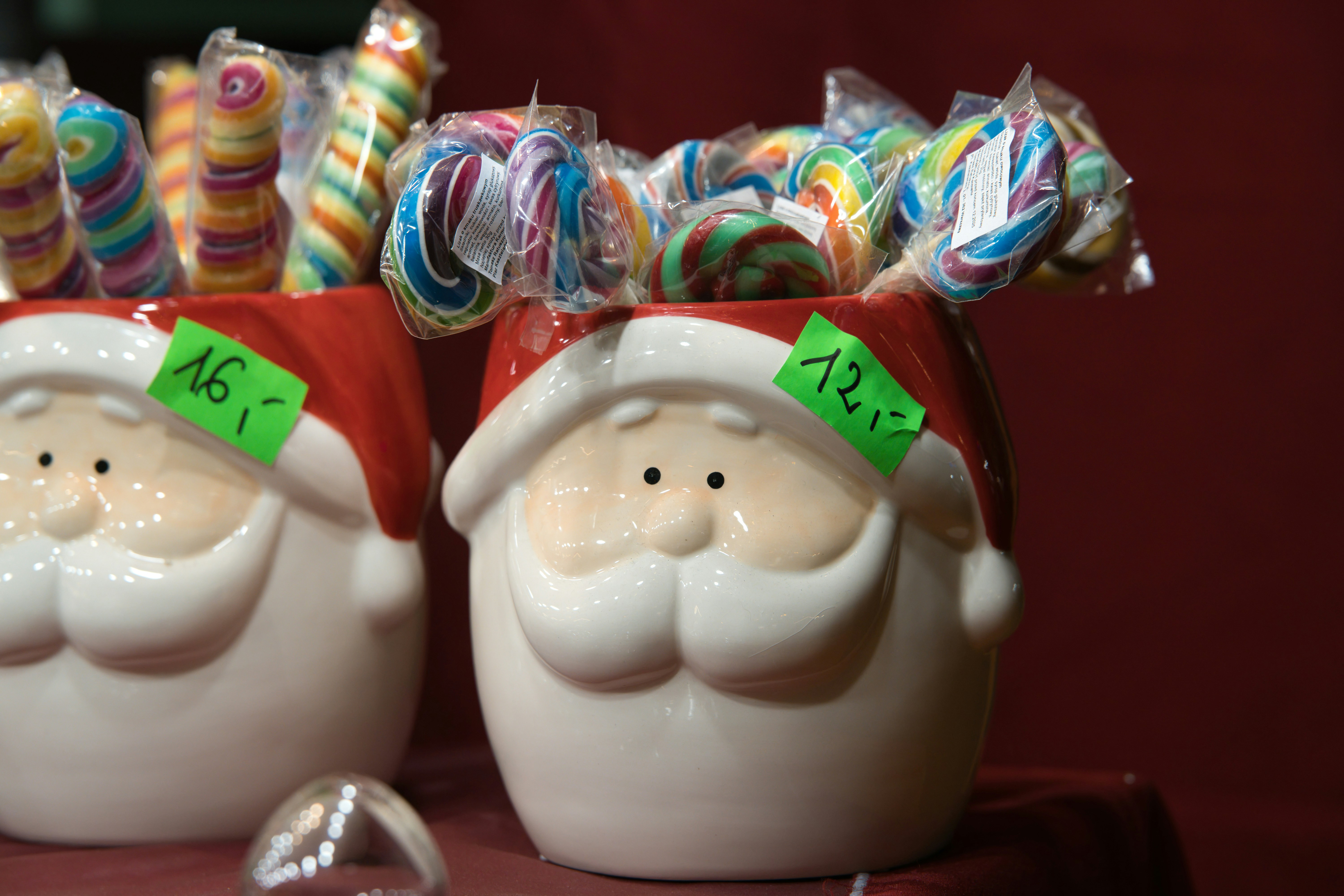 Santa claus mugs filled with colorful lollipops