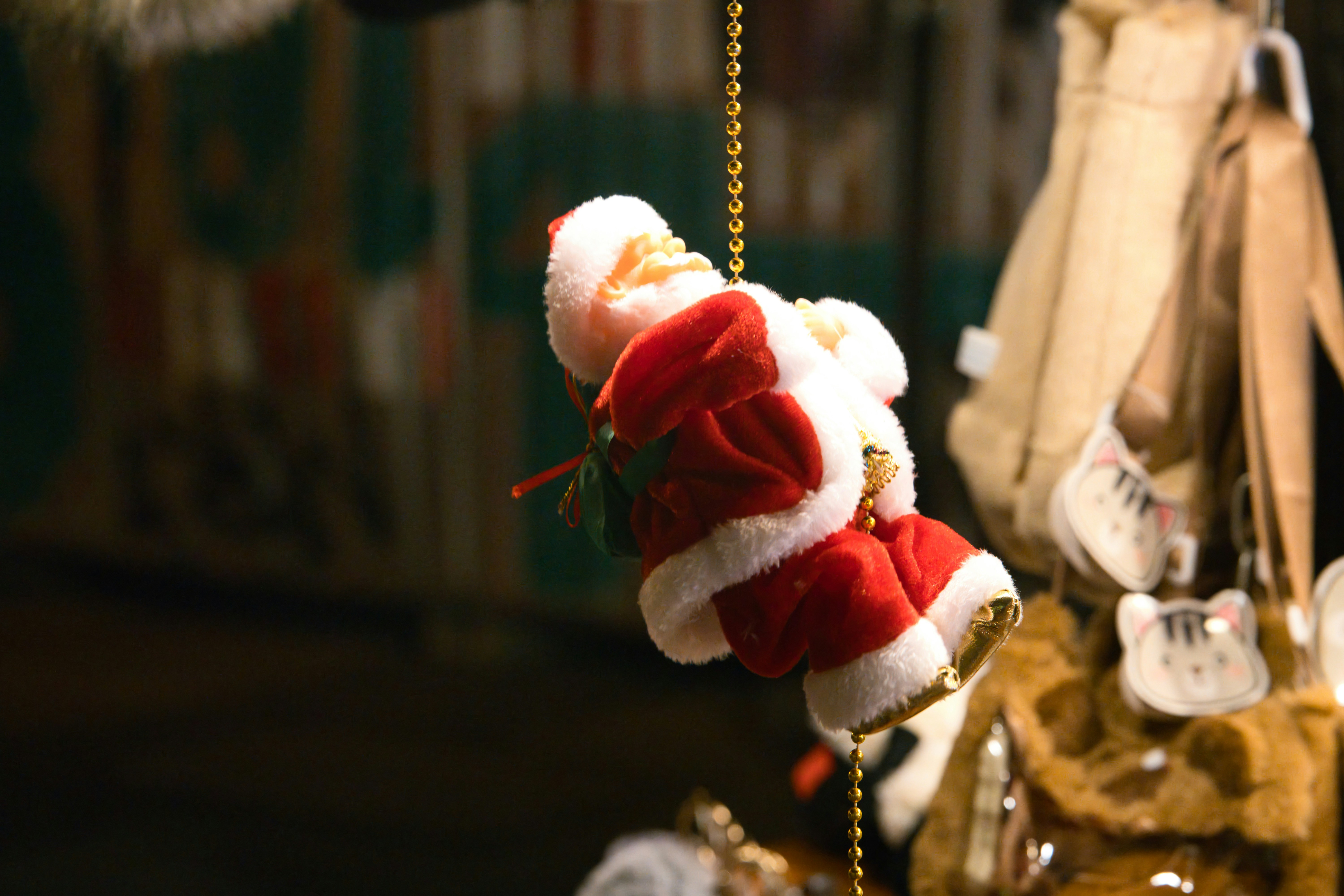 Santa claus ornament hanging on a golden string