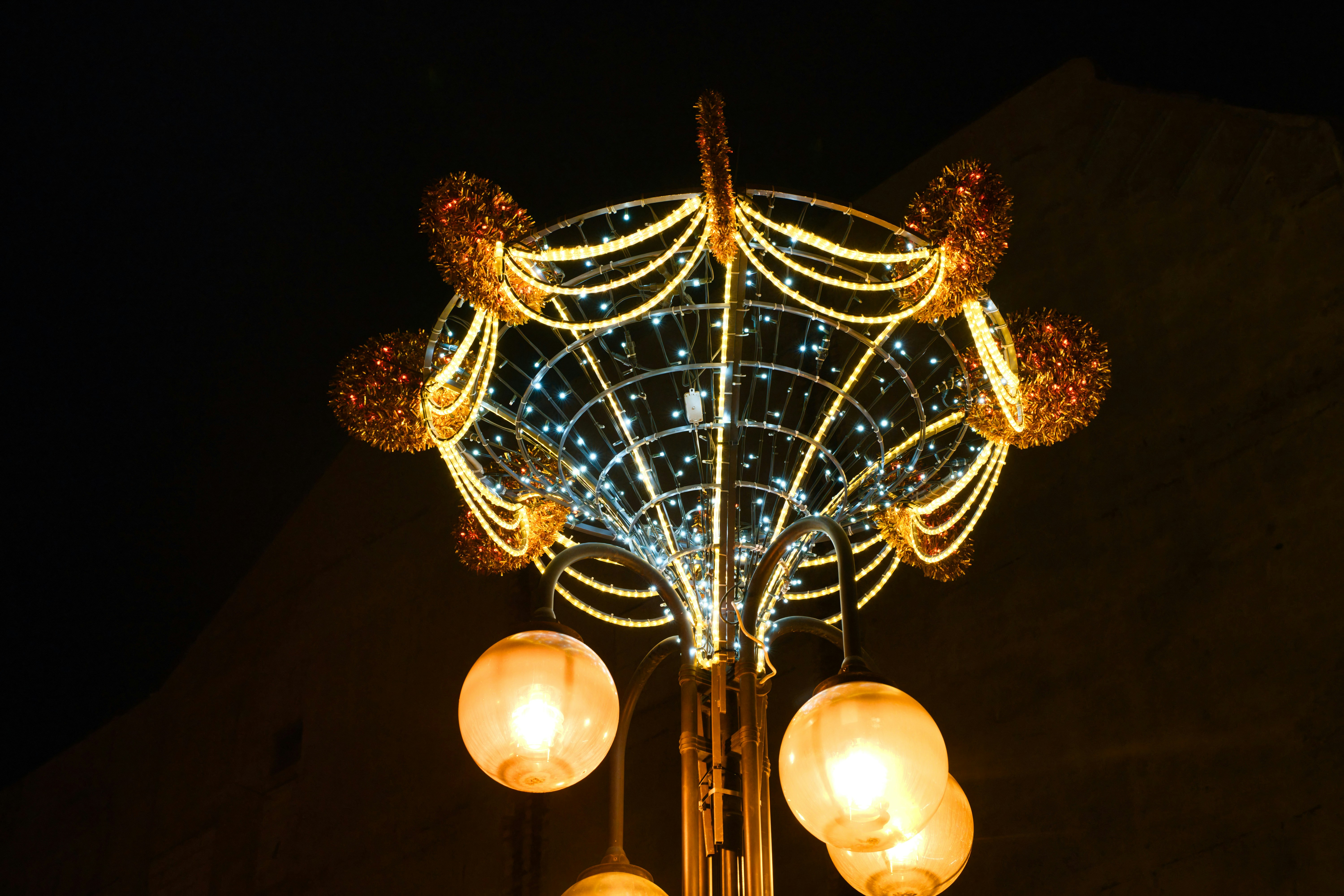 Decorative street light with glowing orbs at night