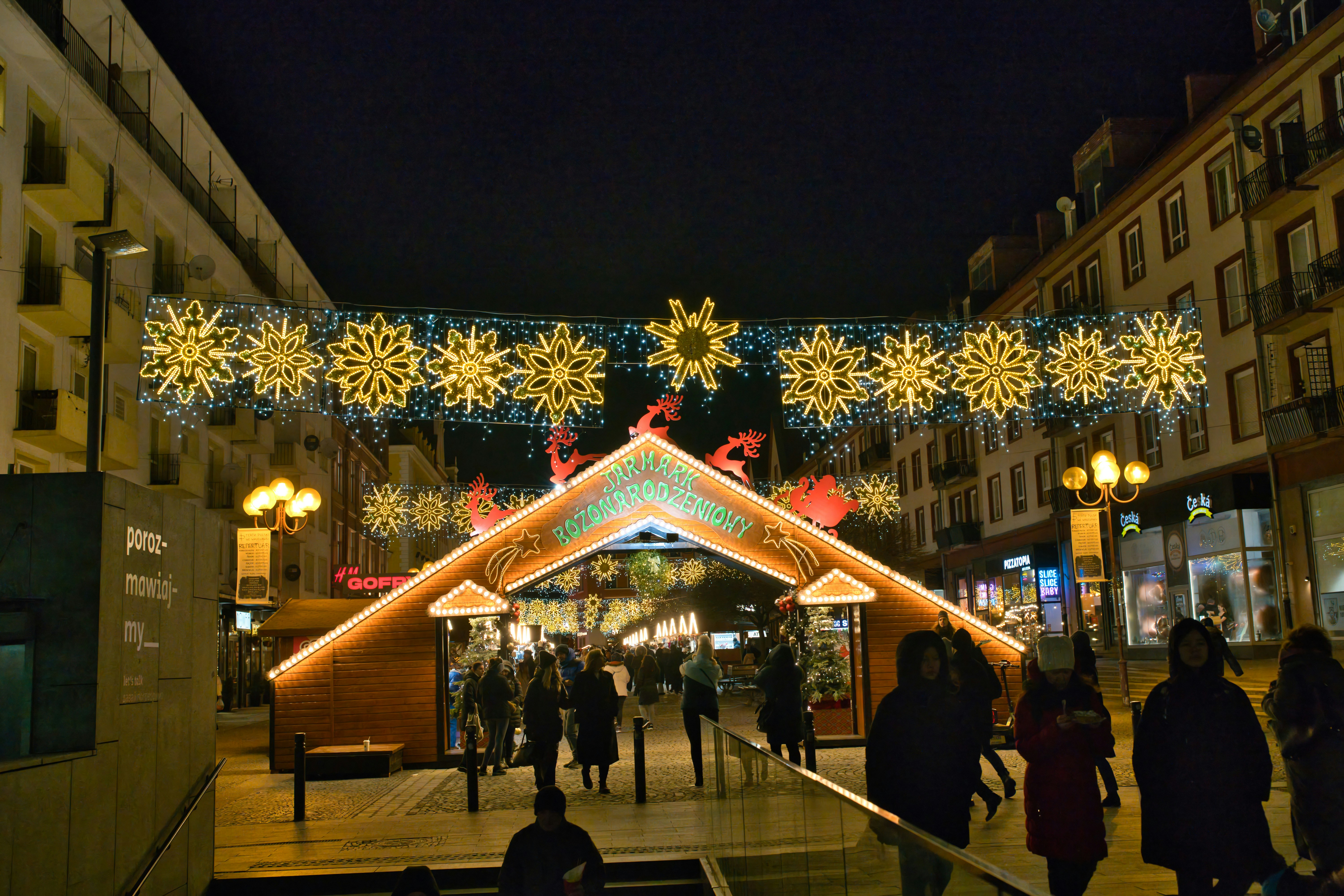 Street decorated with christmas lights at night