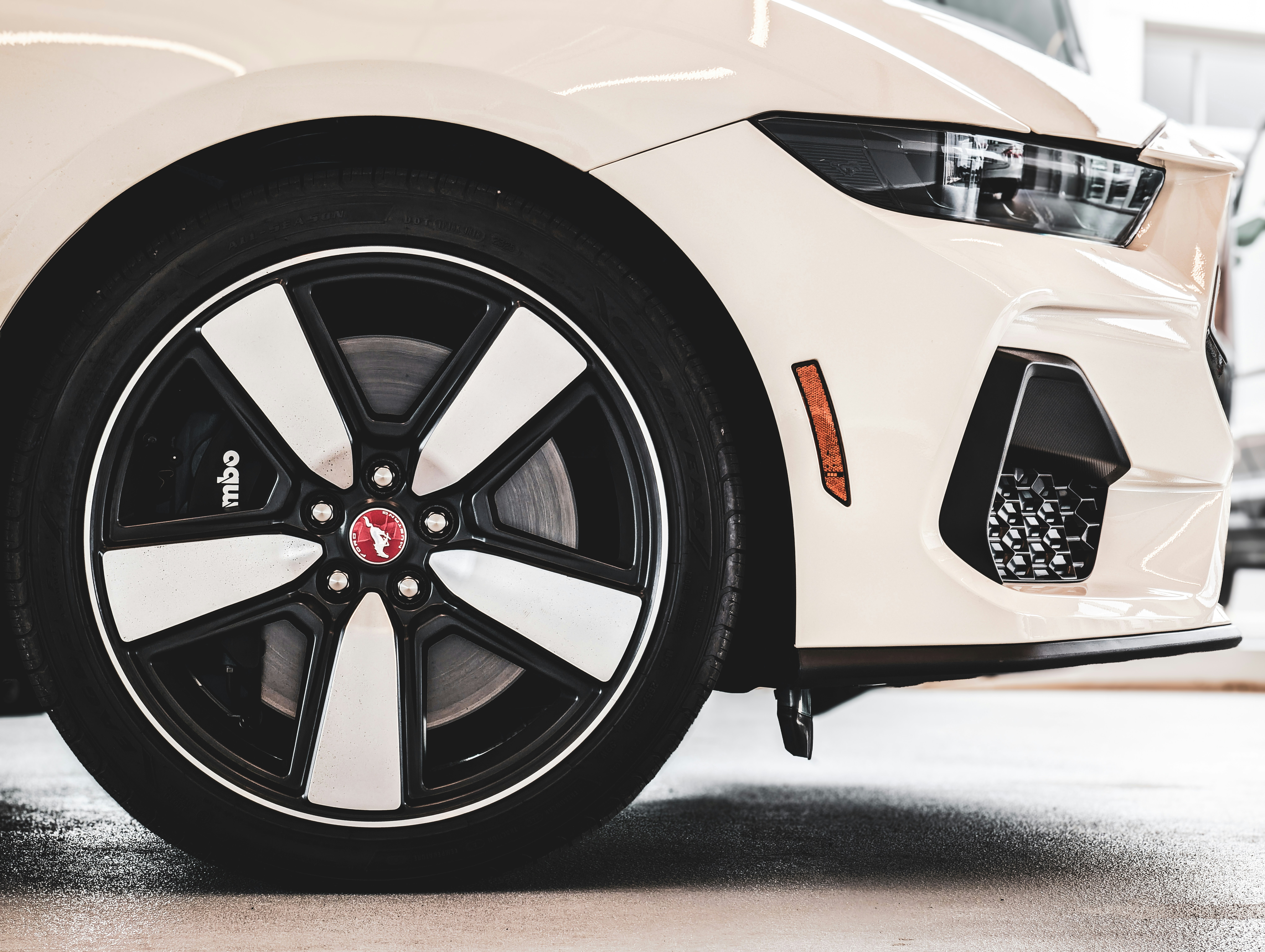Close-up of a white car wheel and fender