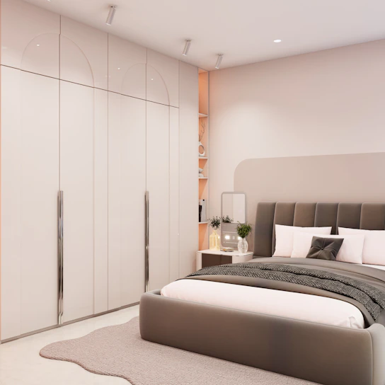 Modern bedroom with large wardrobe and bed.