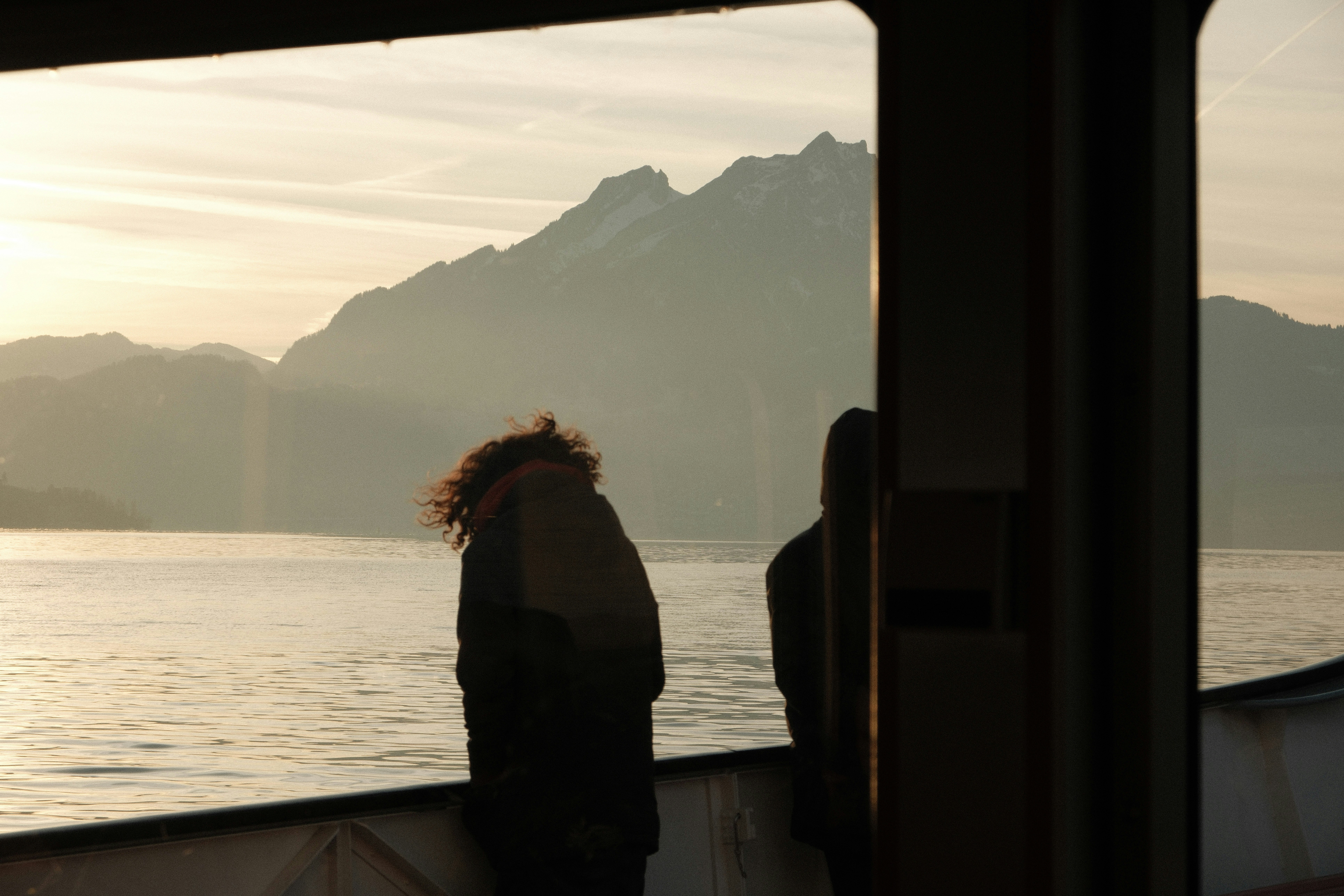 People in a ferry boat at sunset.