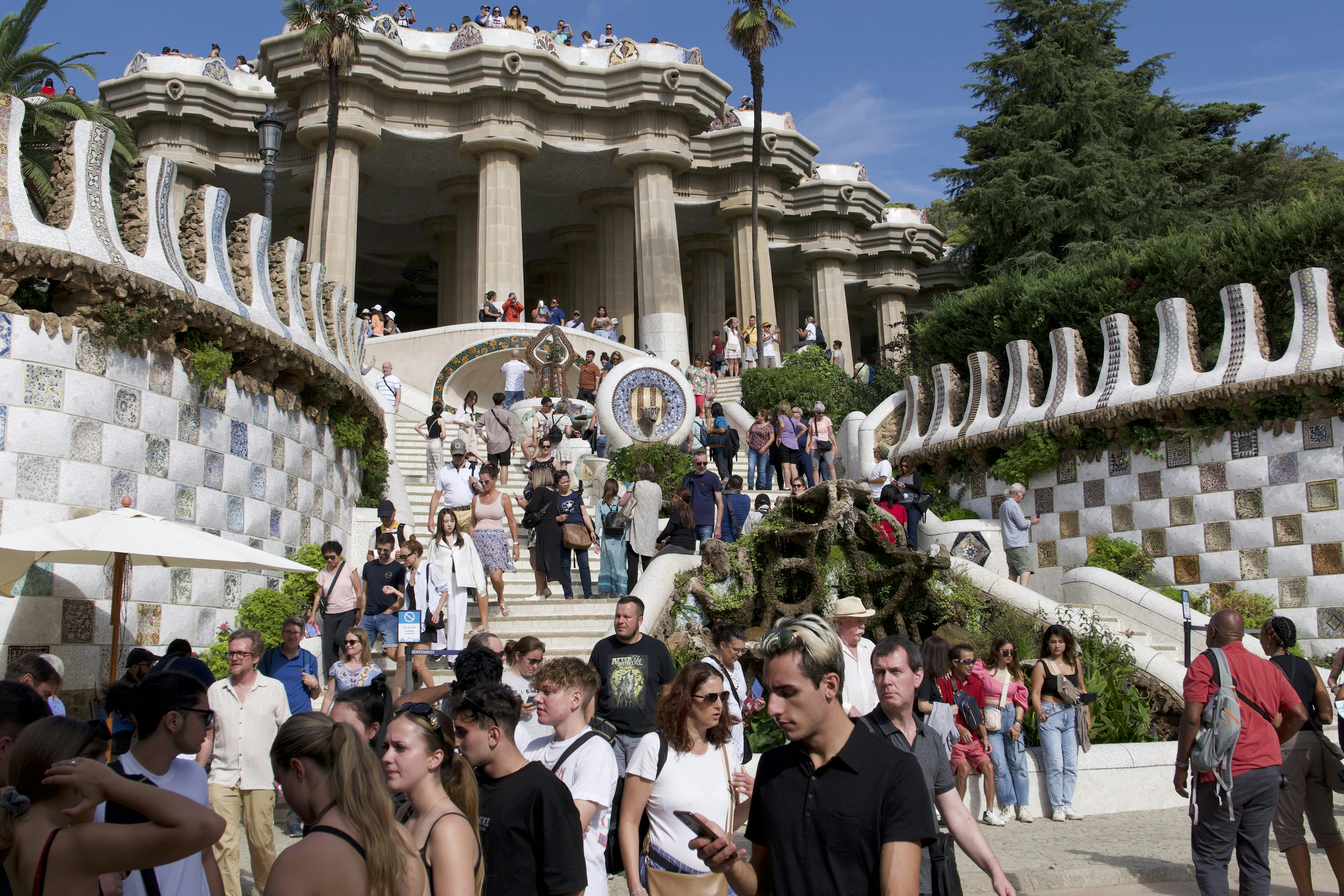 People walking up stairs at park güell, barcelona