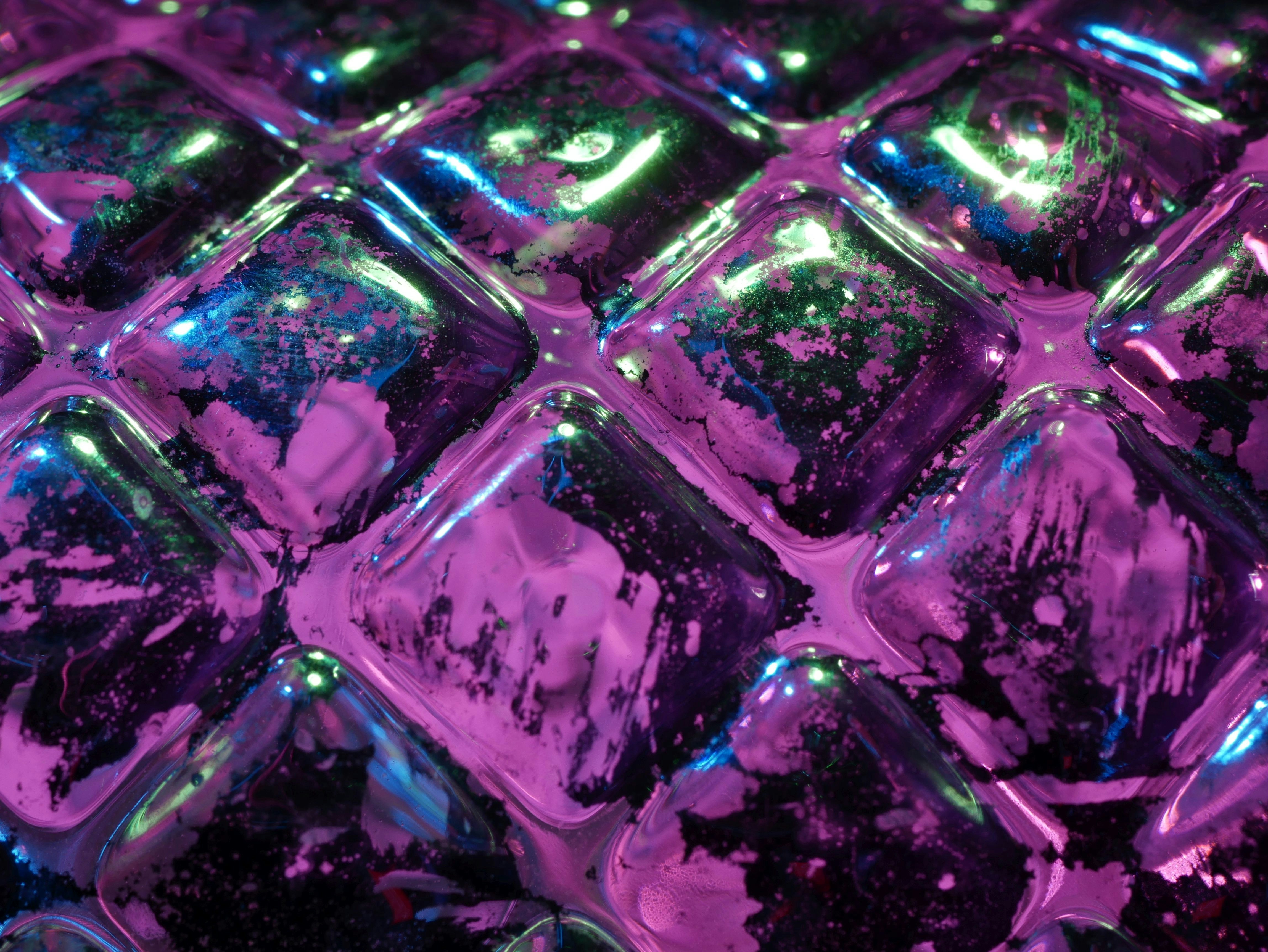 Close up of purple and green textured surface.