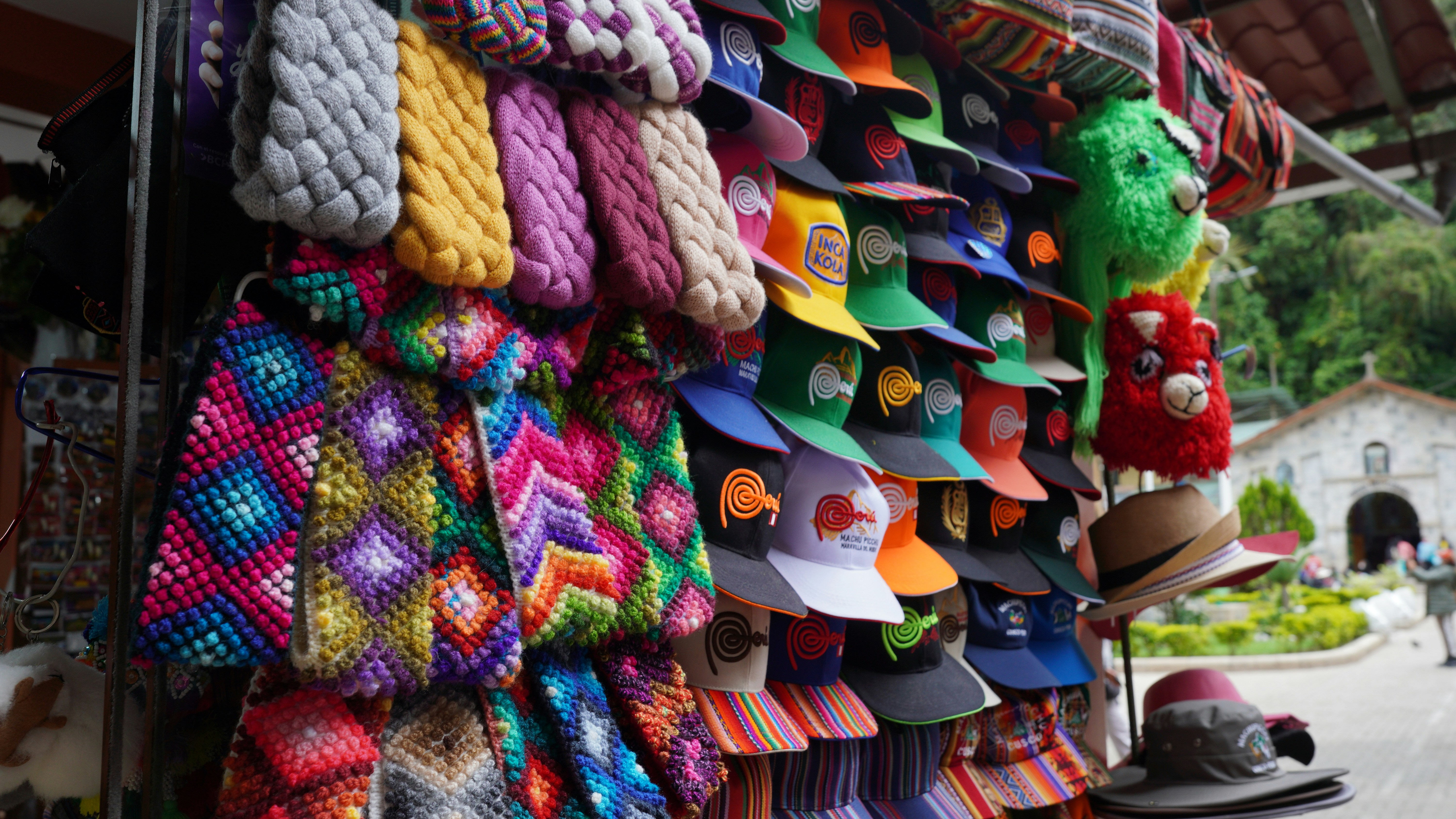 Colorful handmade hats and scarves displayed at market