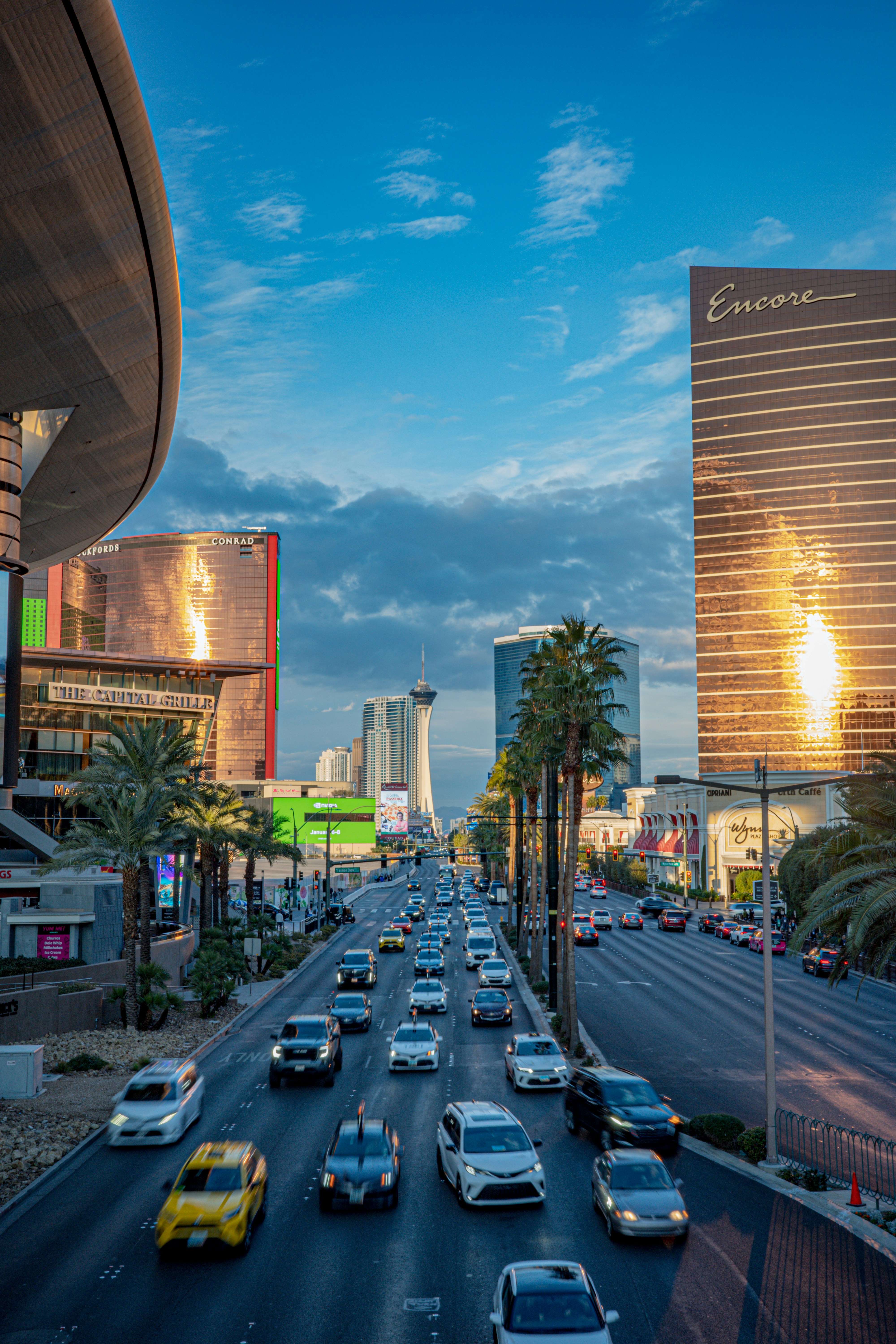 Traffic on a busy street in las vegas at dusk.