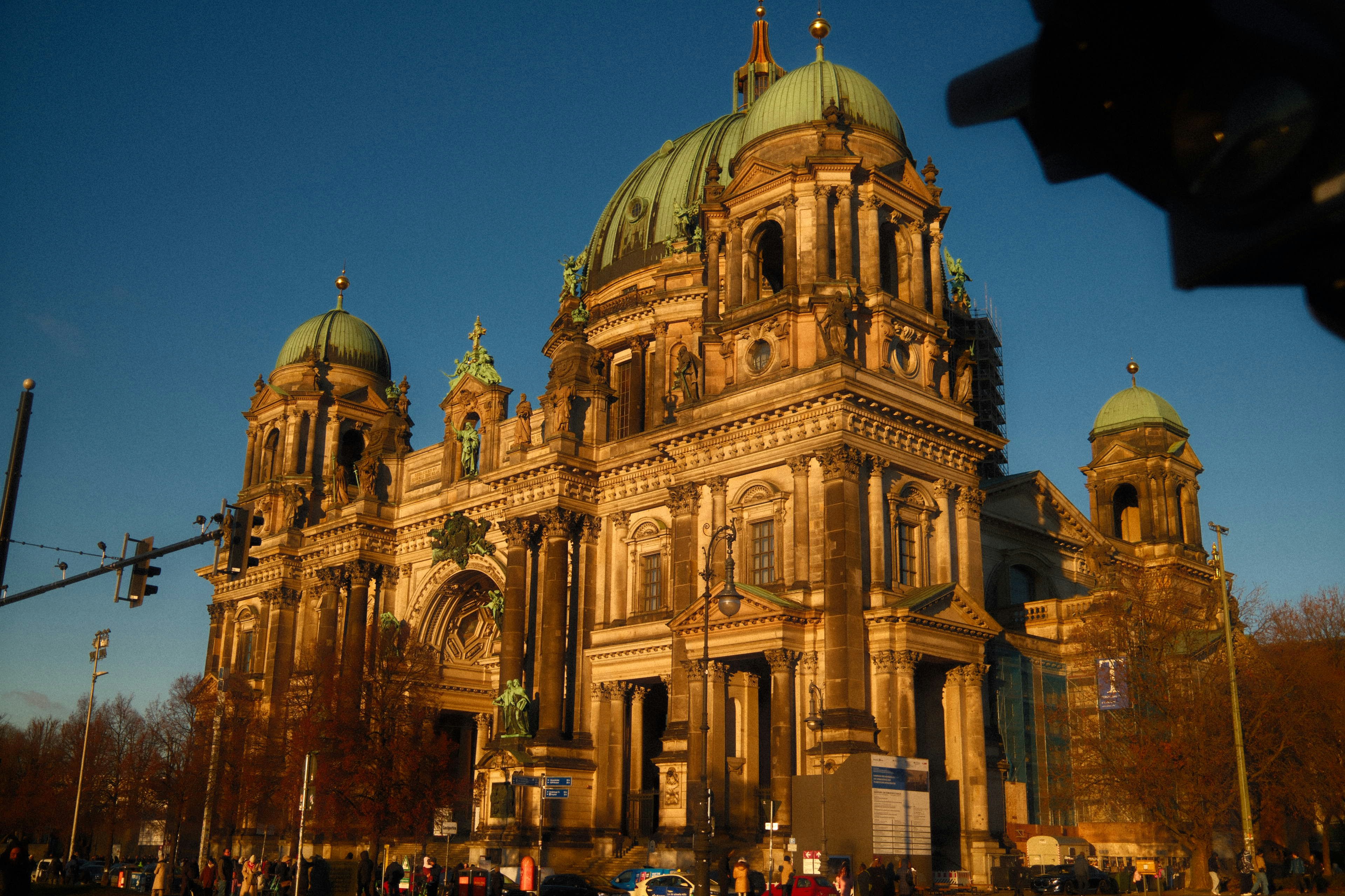Grand cathedral building bathed in golden sunlight.