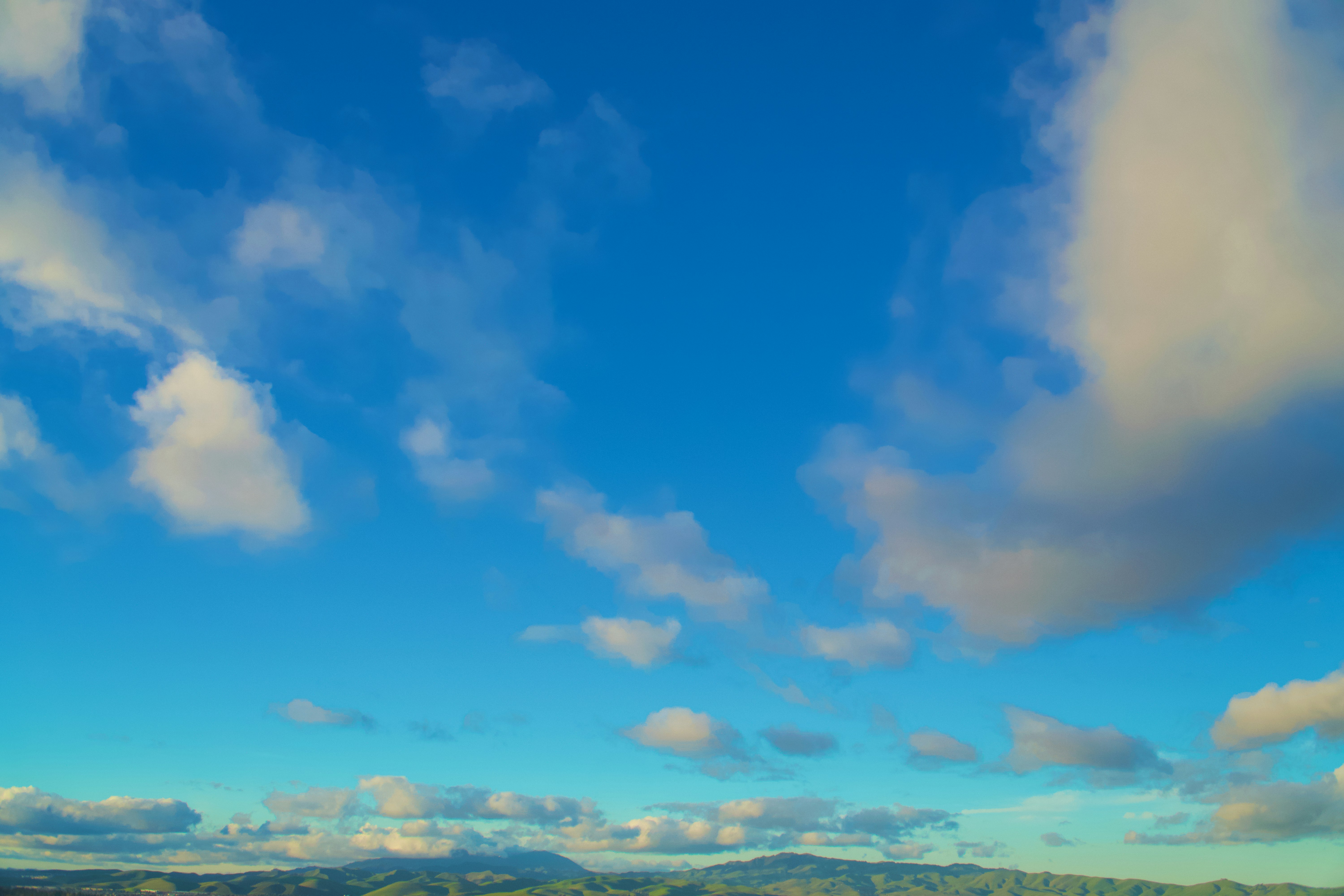 Bright blue sky with scattered white clouds