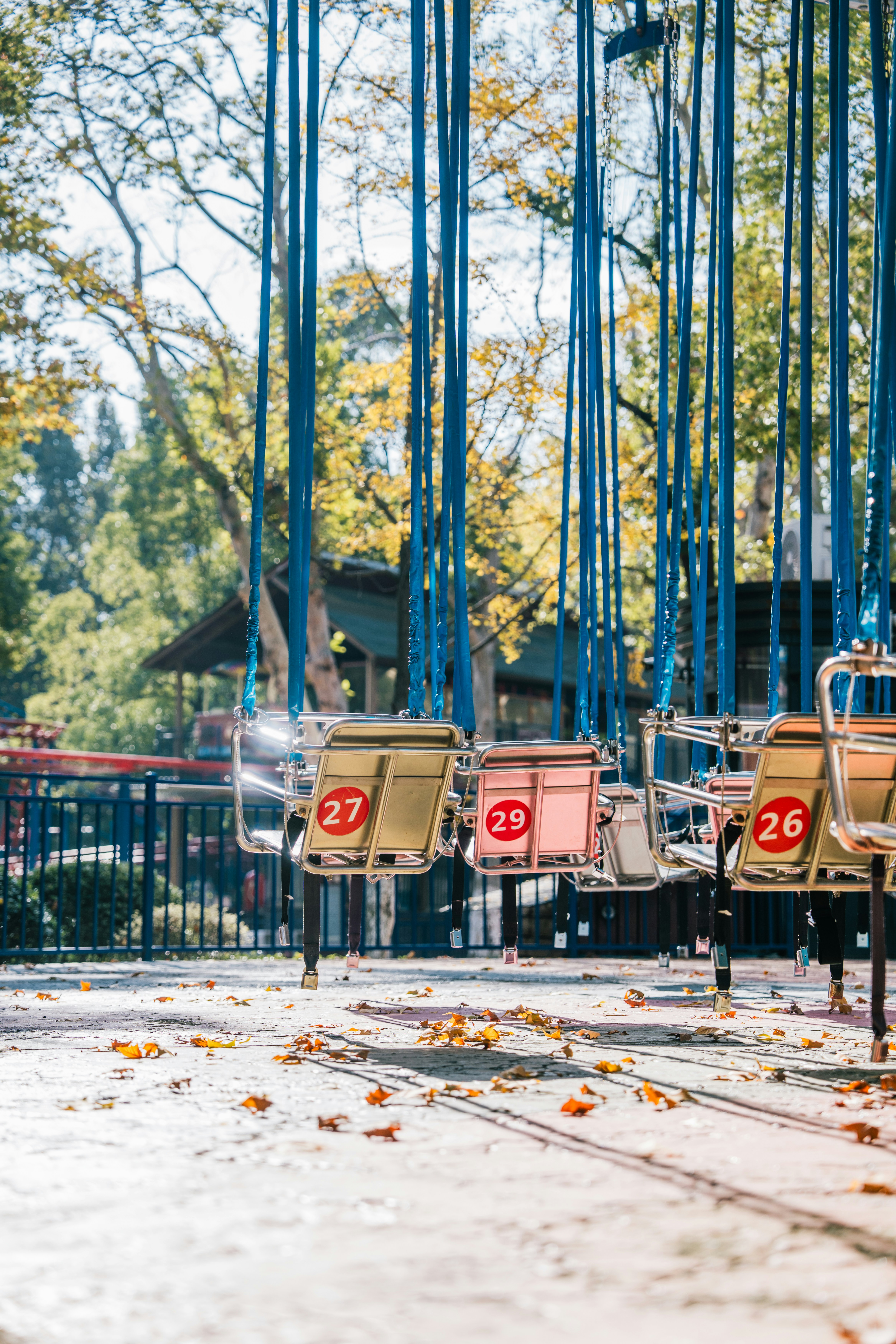 Empty swing ride seats at an amusement park.