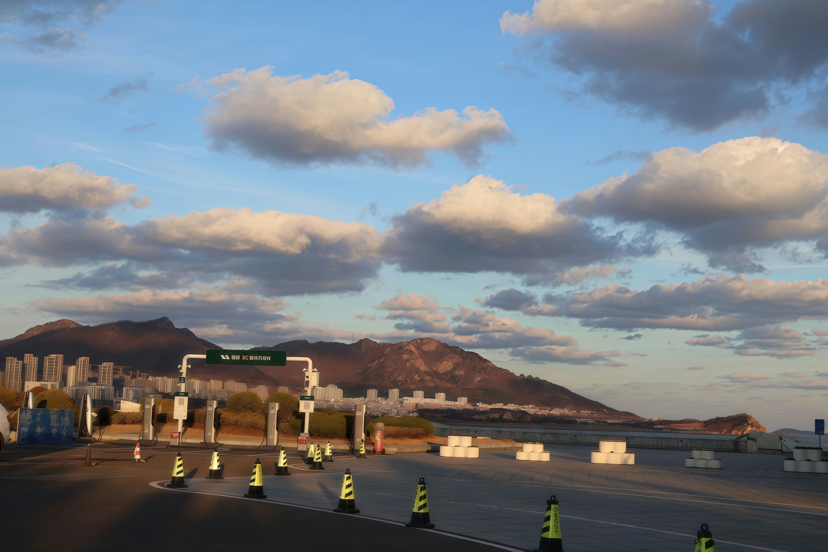 Highway toll plaza with mountains and clouds