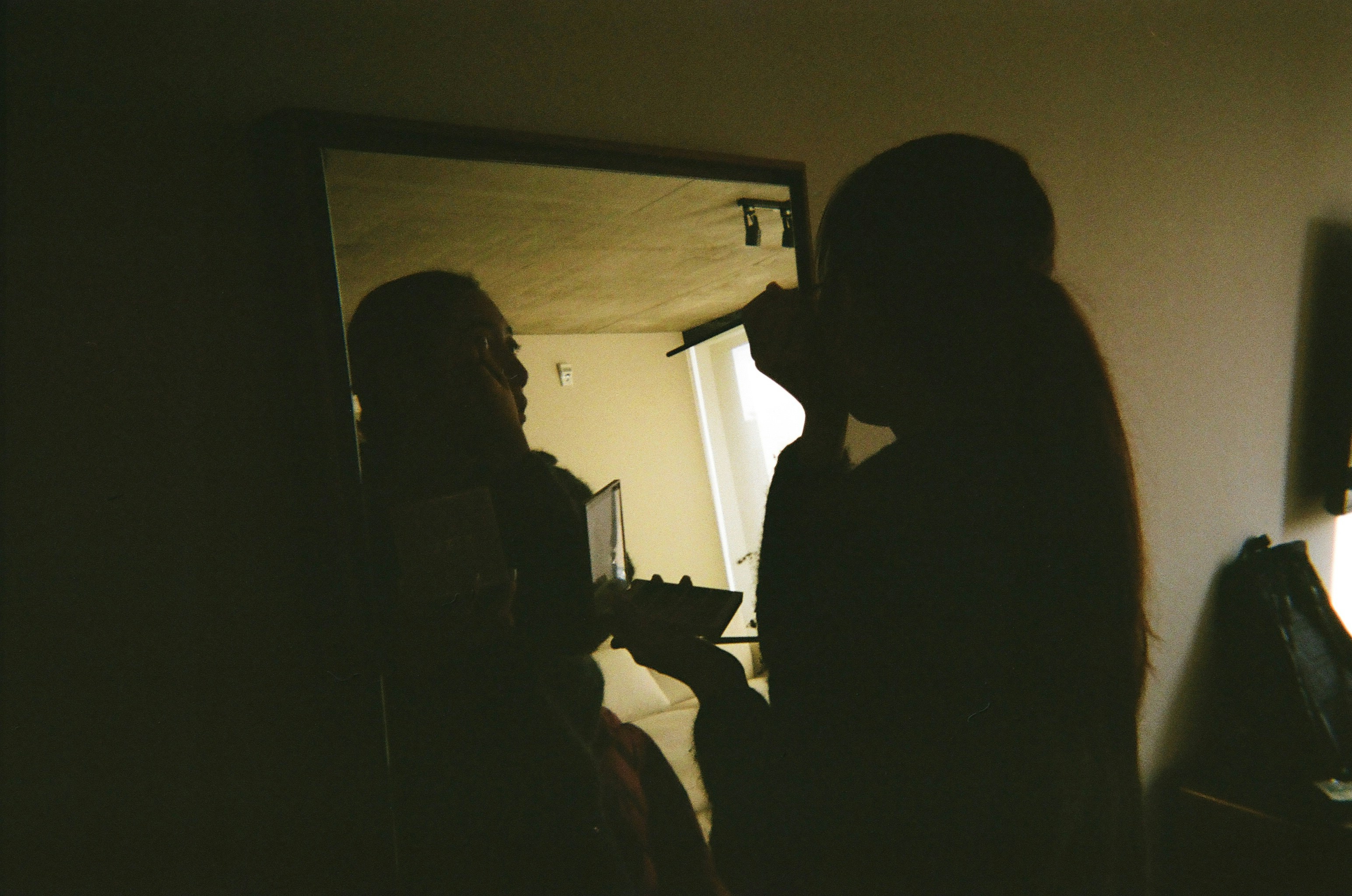 Silhouette of a person singing into a microphone