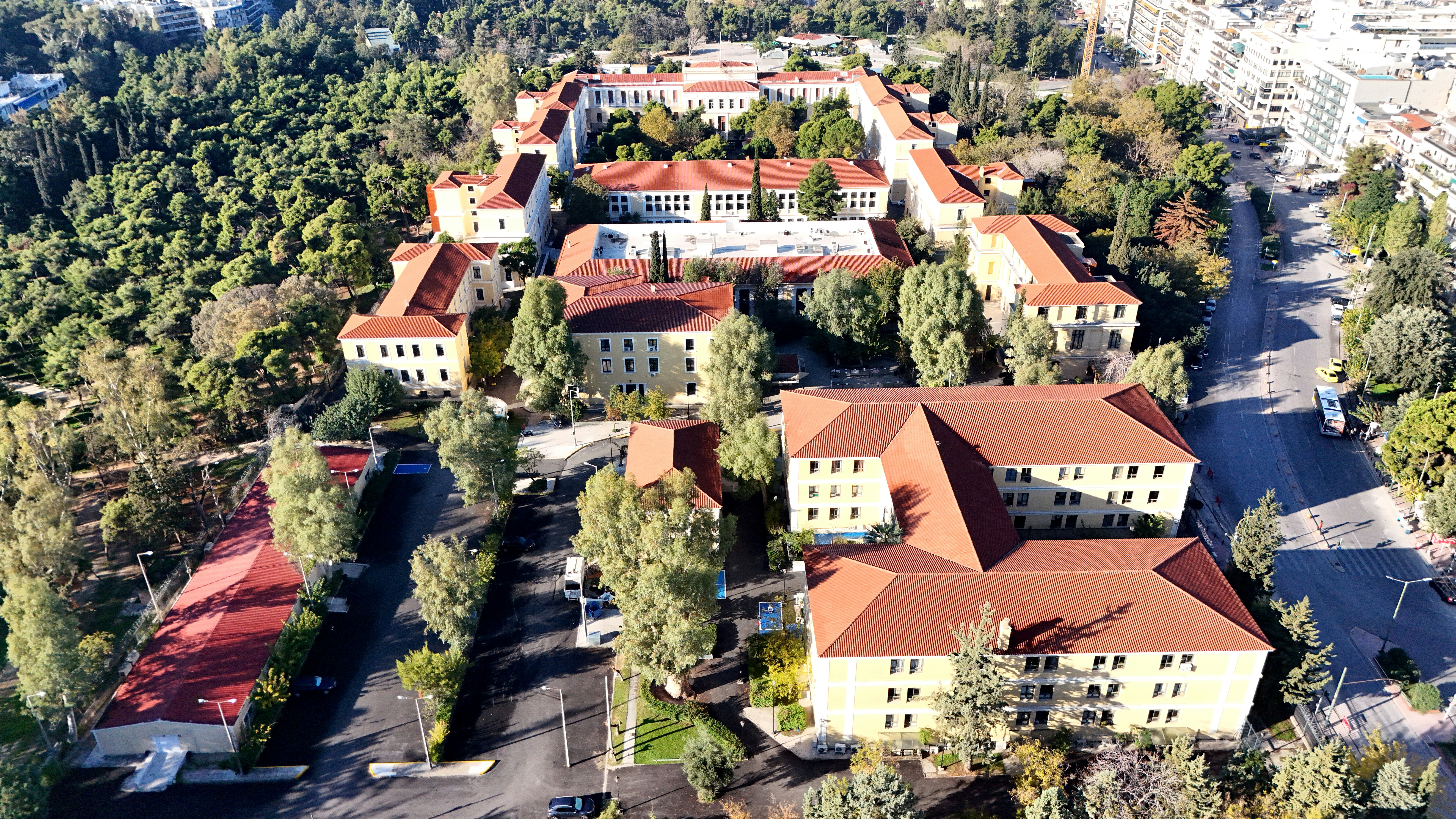 Aerial view of a large campus with red-roofed buildings.