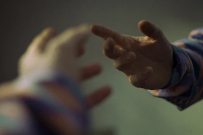 Two hands reaching out towards each other