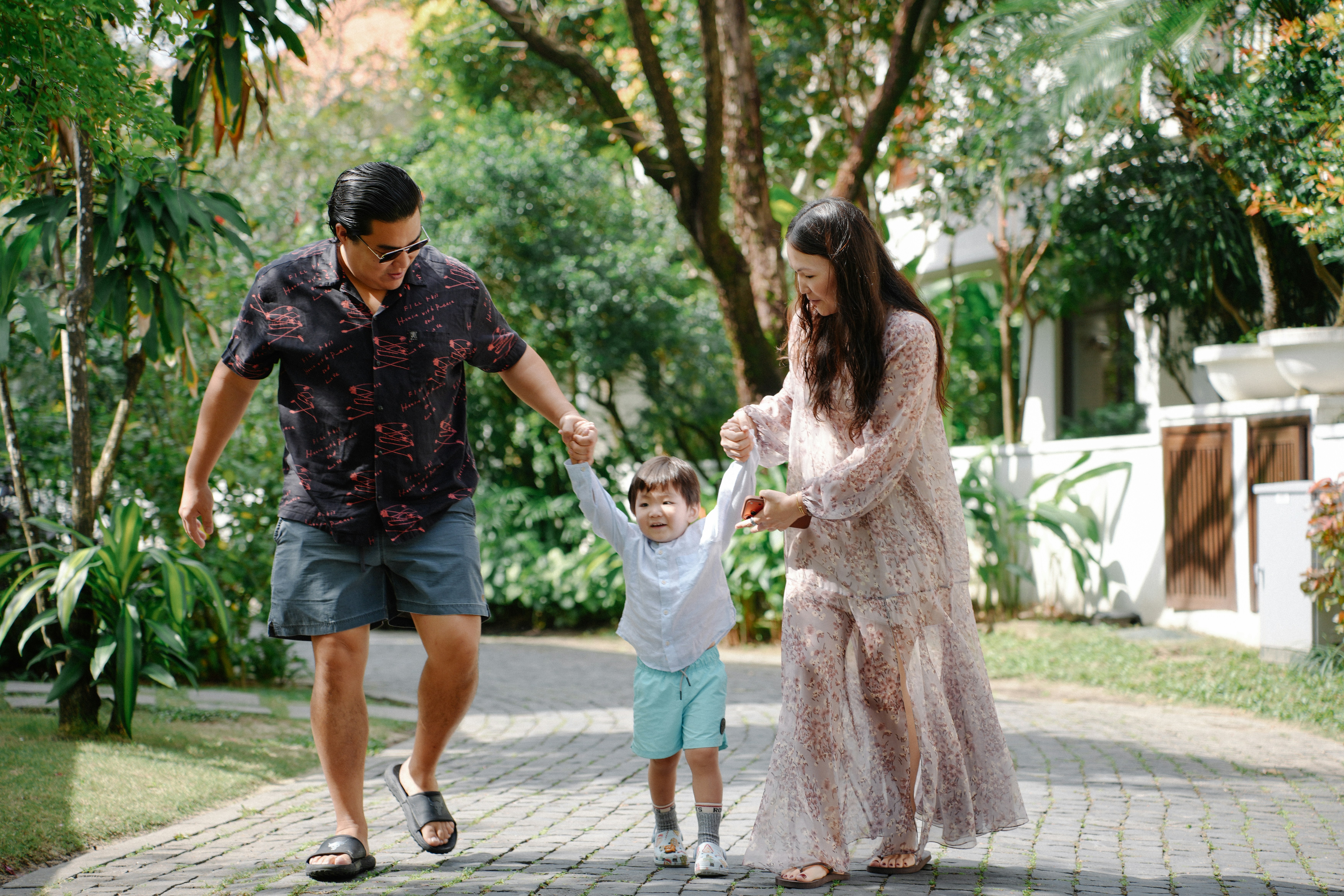 Family walking together on a paved path outdoors
