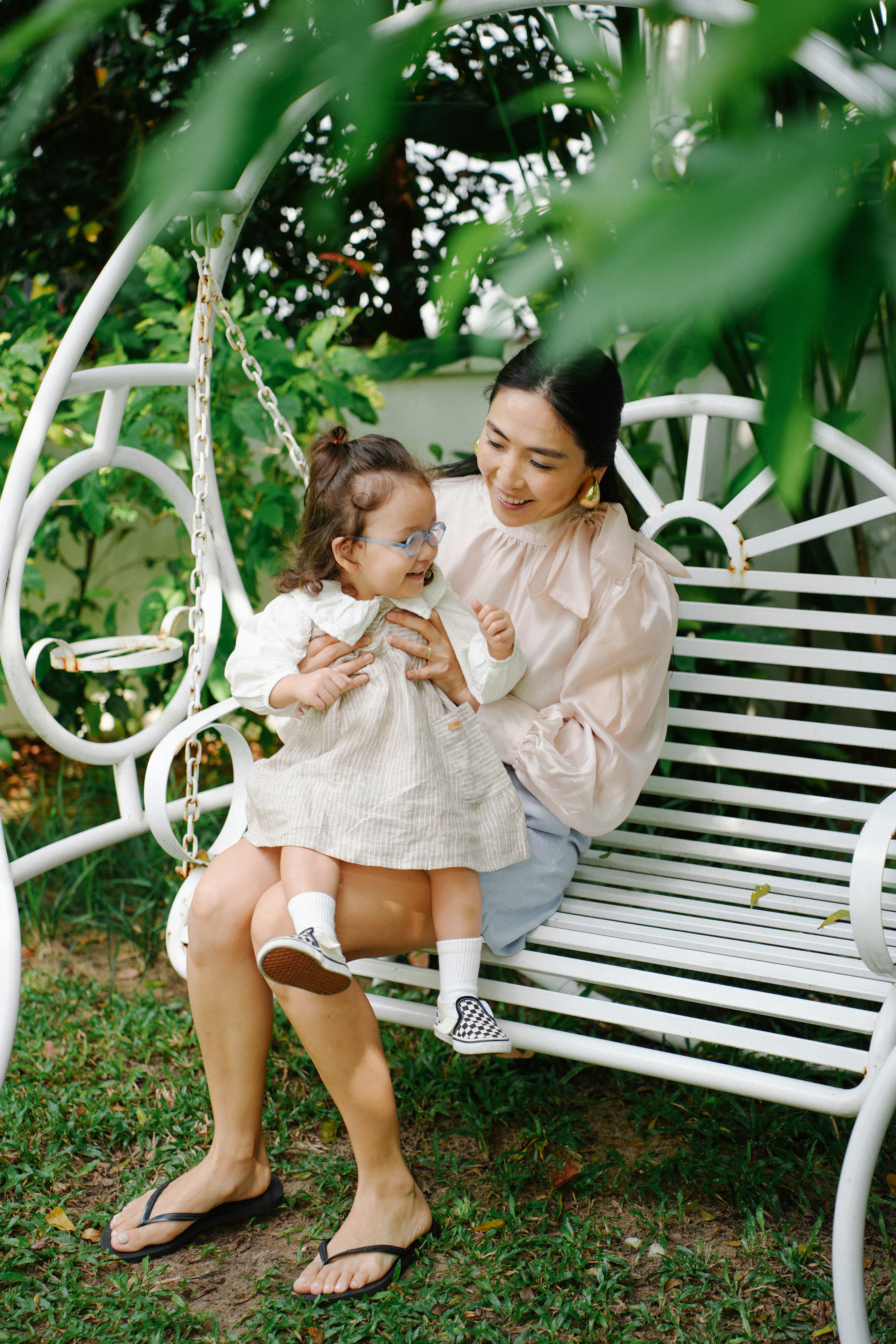 Mother and child sitting on a swing