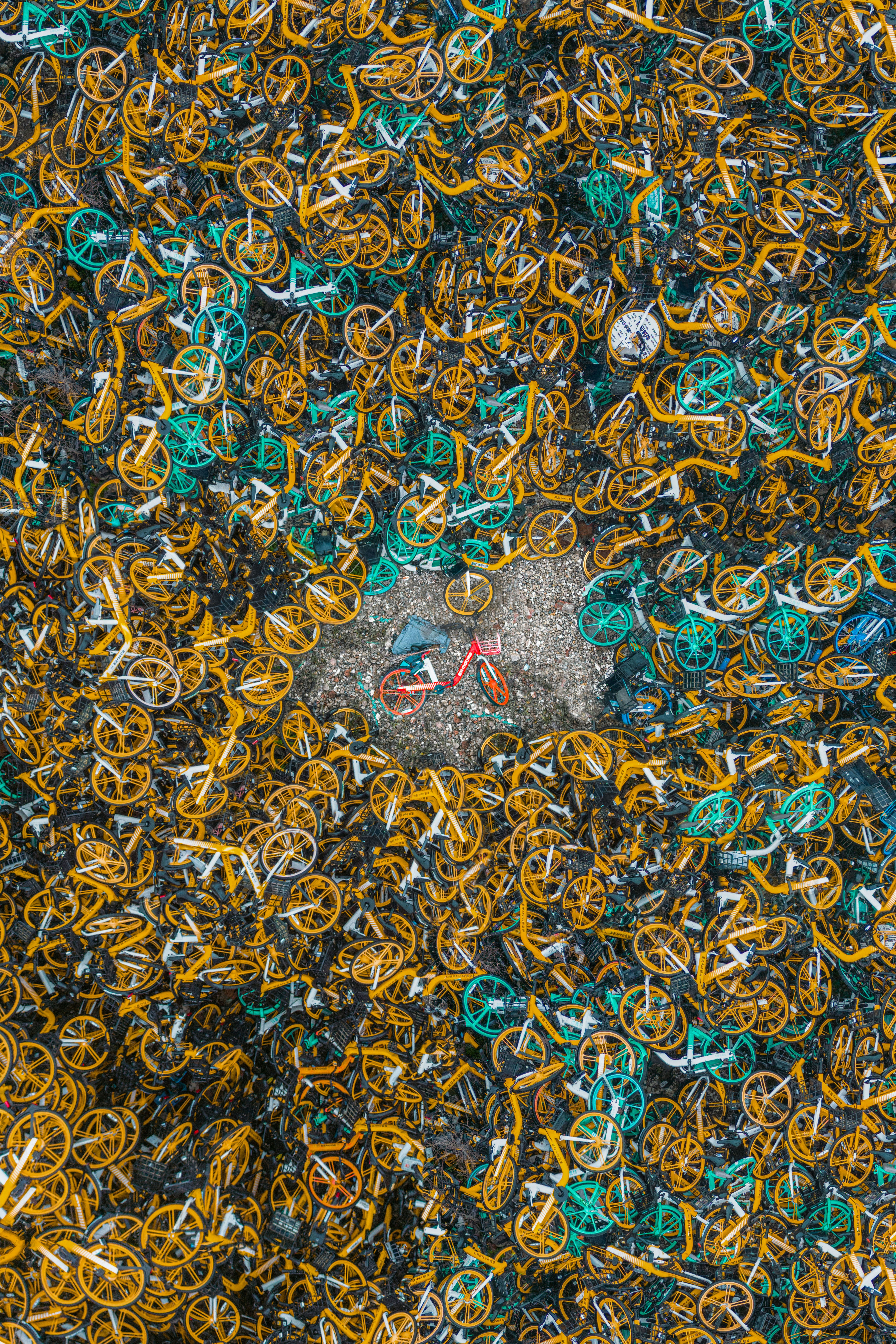 Pile of discarded yellow and green bicycles