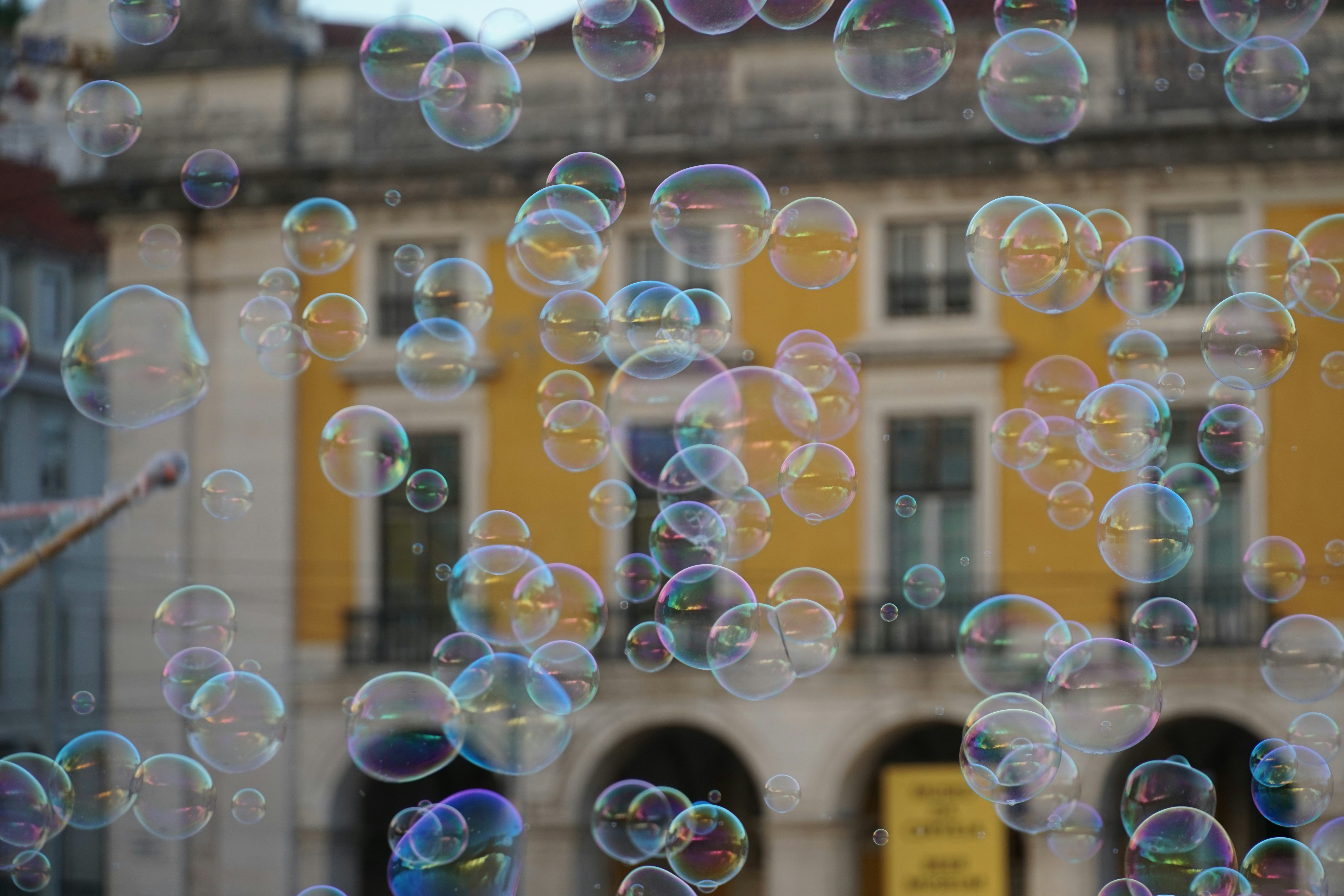 Bubbles floating in front of a yellow building.