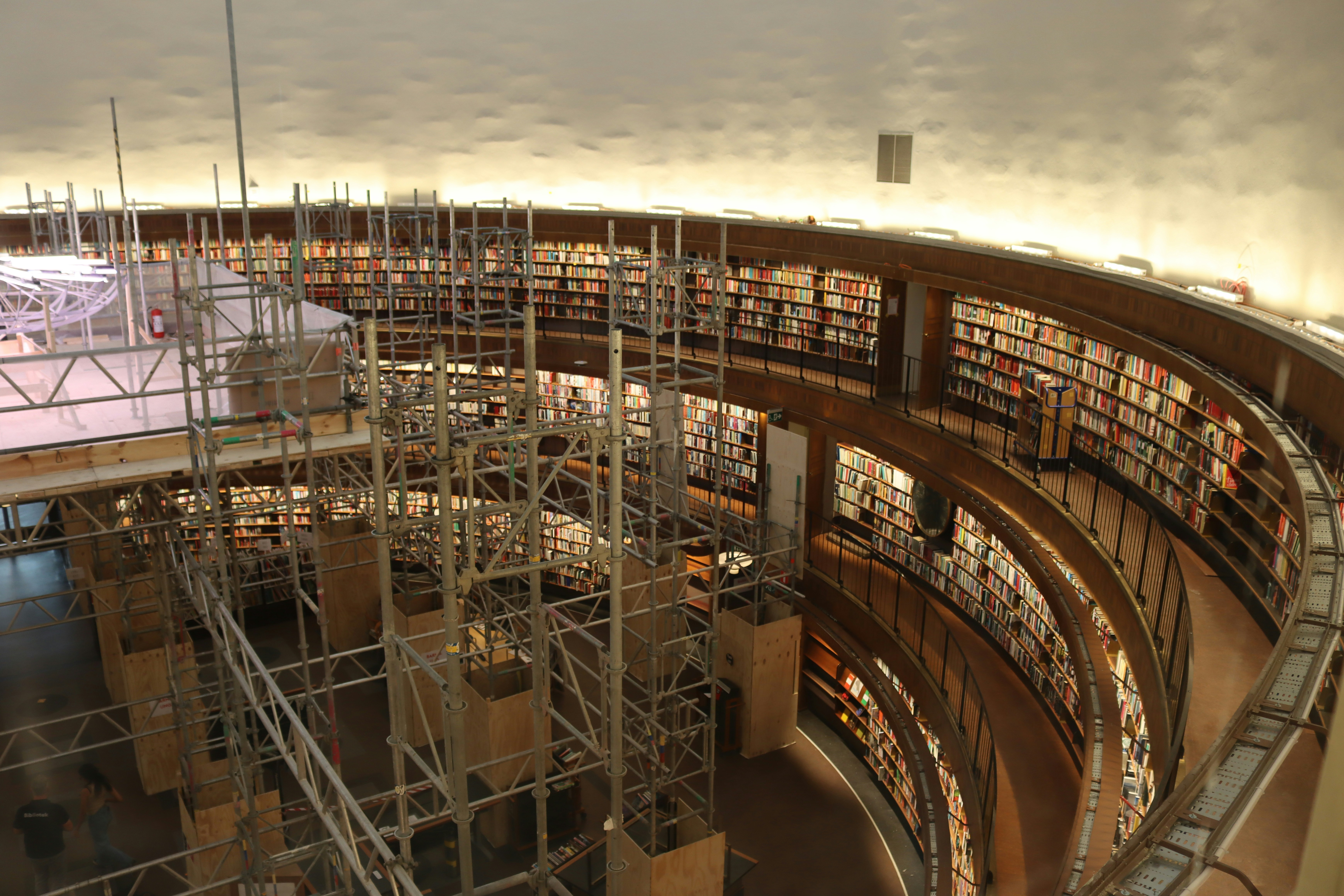 Circular library with bookshelves and scaffolding