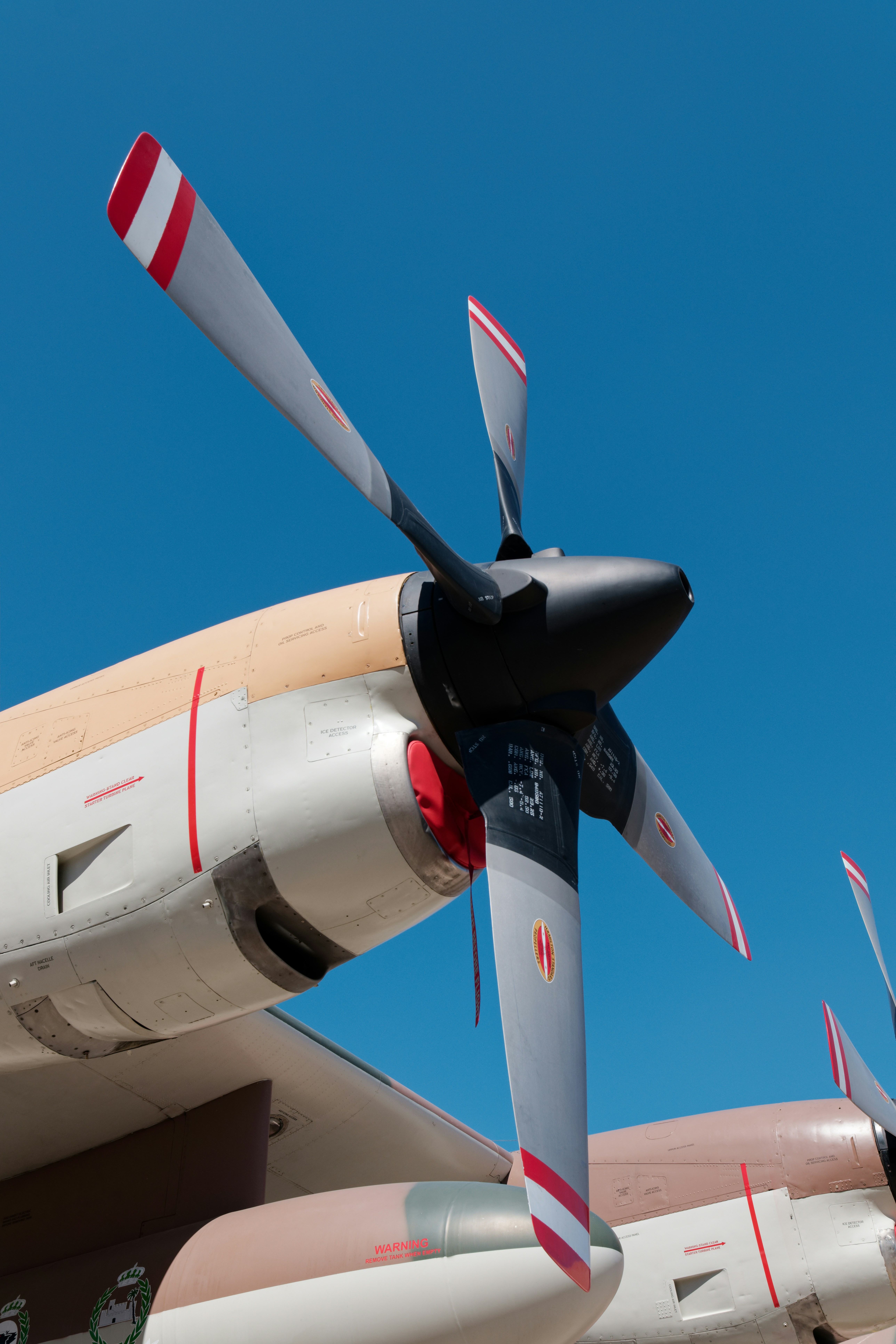 Airplane propeller against a clear blue sky.