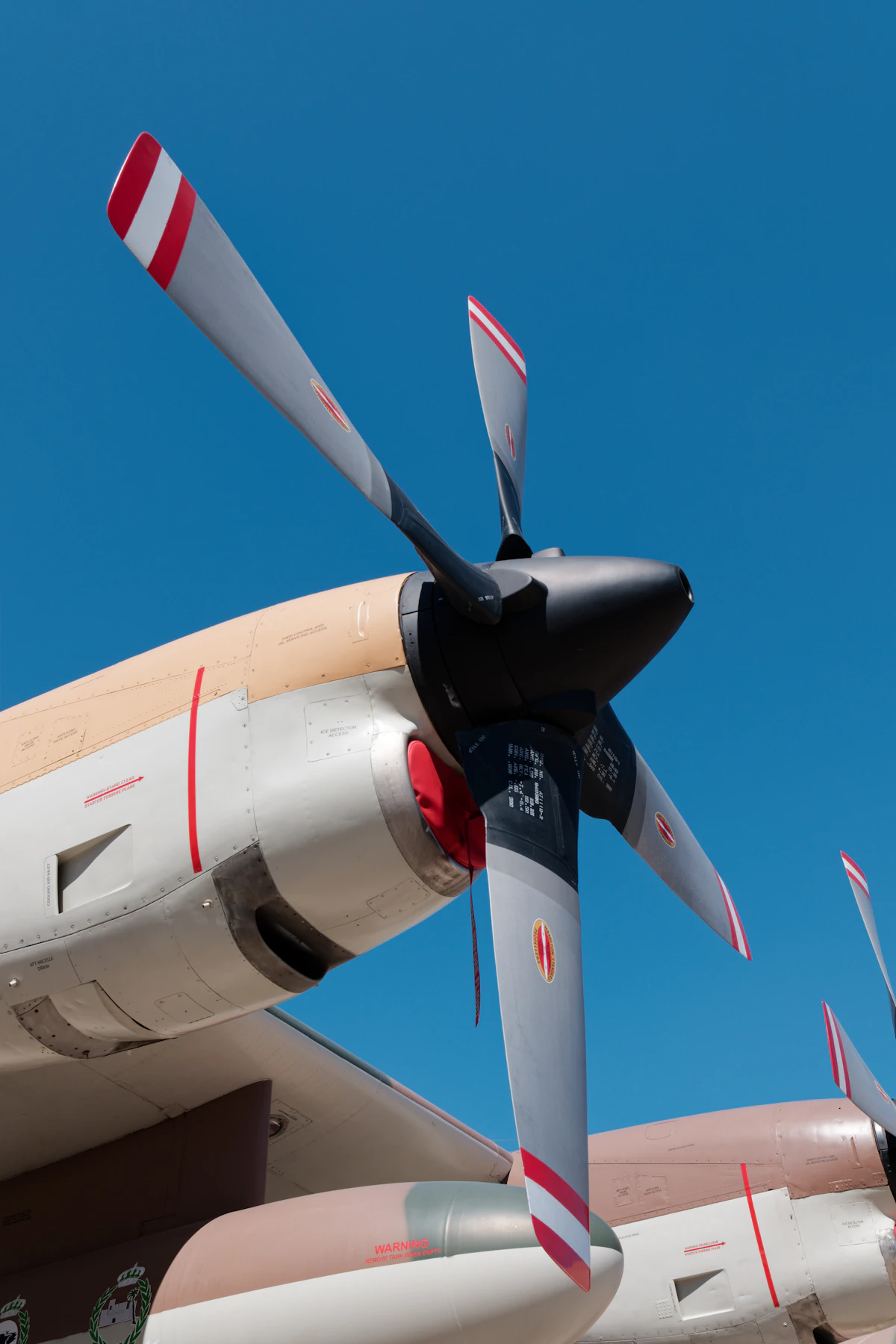 The propeller and engine nacelle of a turboprop airliner on the apron