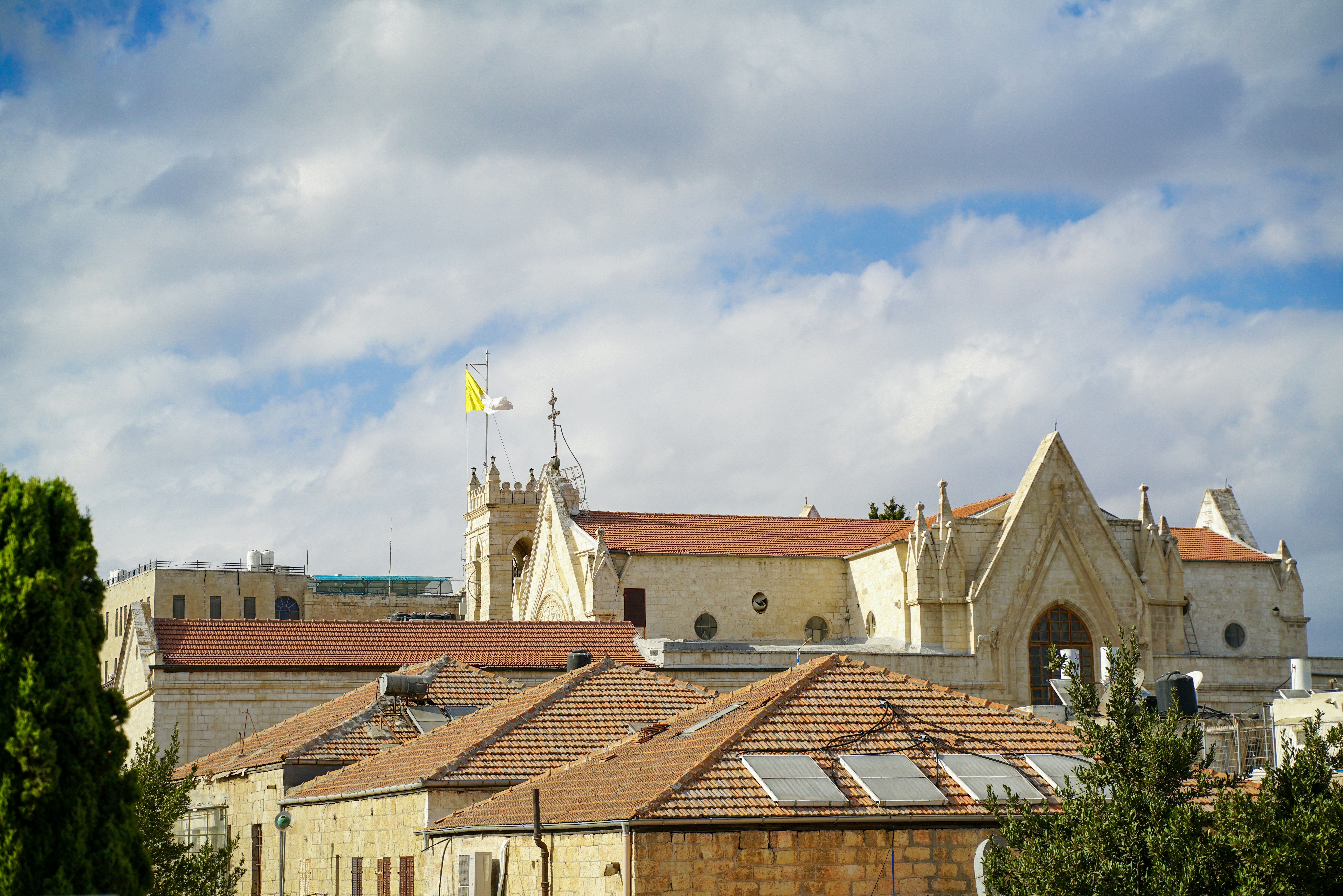 Old building with red tiled roofs under clouds
