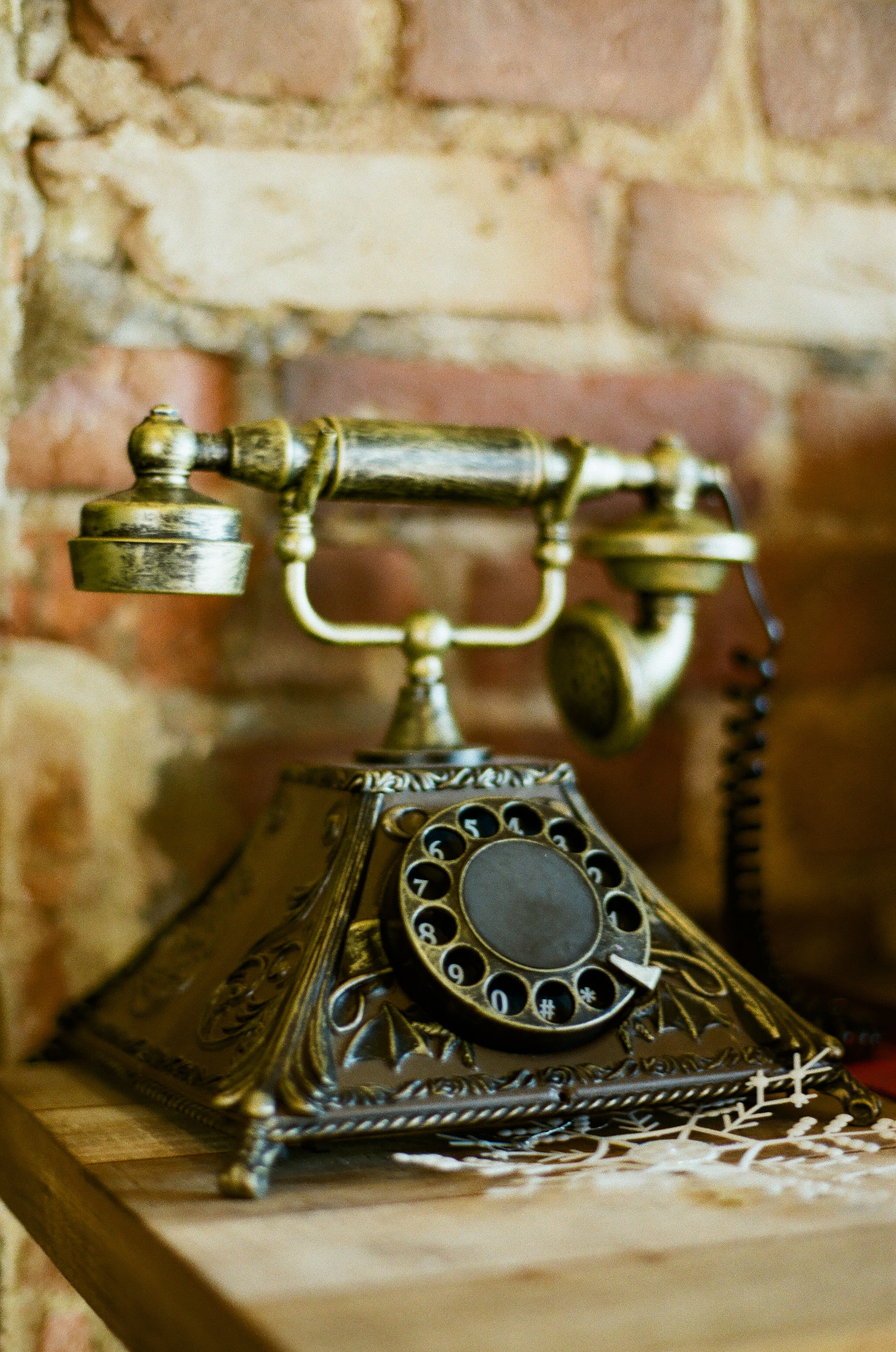 Antique rotary telephone on a wooden shelf