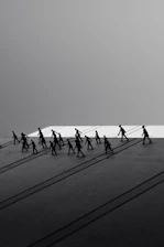 Silhouettes of people walking with long shadows