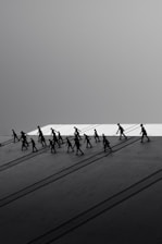 Silhouettes of people walking with long shadows