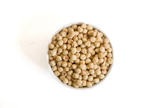 Bowl of dried chickpeas on a white background