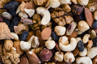 A close-up view of a mixed nut and raisin blend.