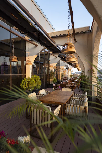 A rooftop restaurant terrace with tables set for dining