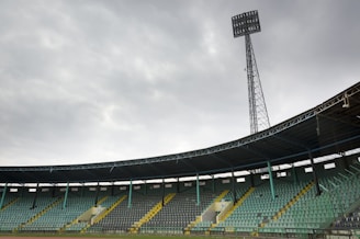 Empty stadium seats under a cloudy sky
