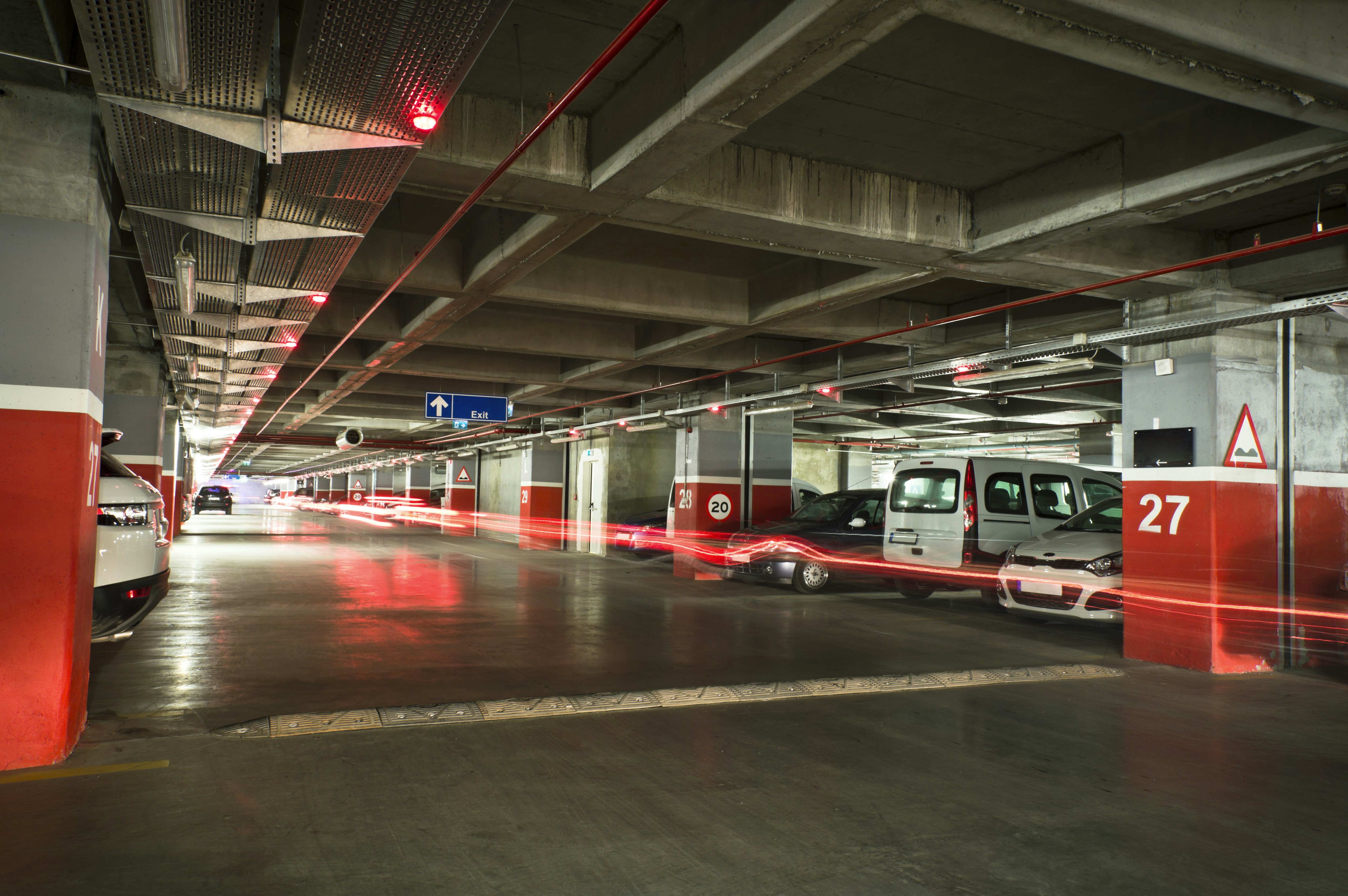 Cars parked in a dimly lit underground garage.